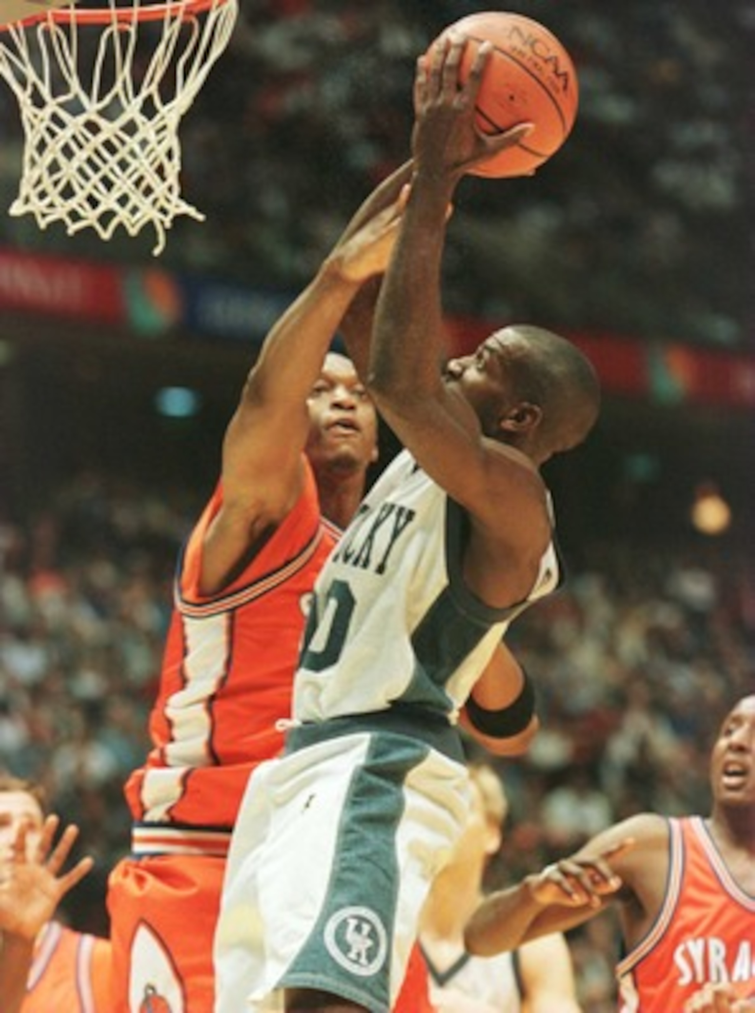 Tony Delk (right) of Kentucky shoots over John Wallace of Syracuse during the 1996 NCAA Men''s Basketball Championship at the Continental Air Arena in East Rutherford, New Jersey.
