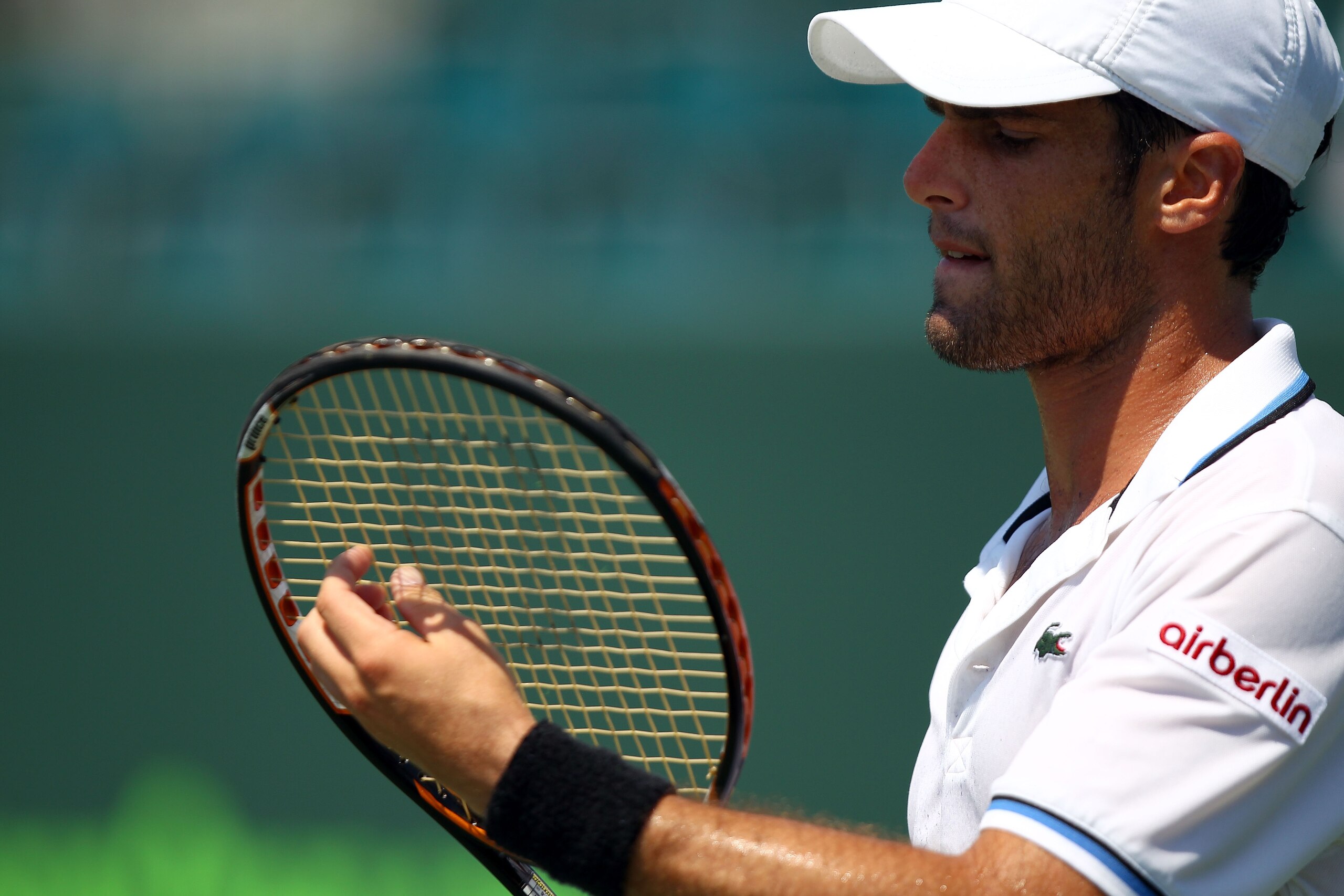 KEY BISCAYNE, FL - MARCH 27:  Pablo Andujar of Spain adjusts his racquet against Kevin Anderson of South Africa during the Sony Ericsson Open at Crandon Park Tennis Center on March 27, 2011 in Key Biscayne, Florida.  (Photo by Clive Brunskill/Getty Images