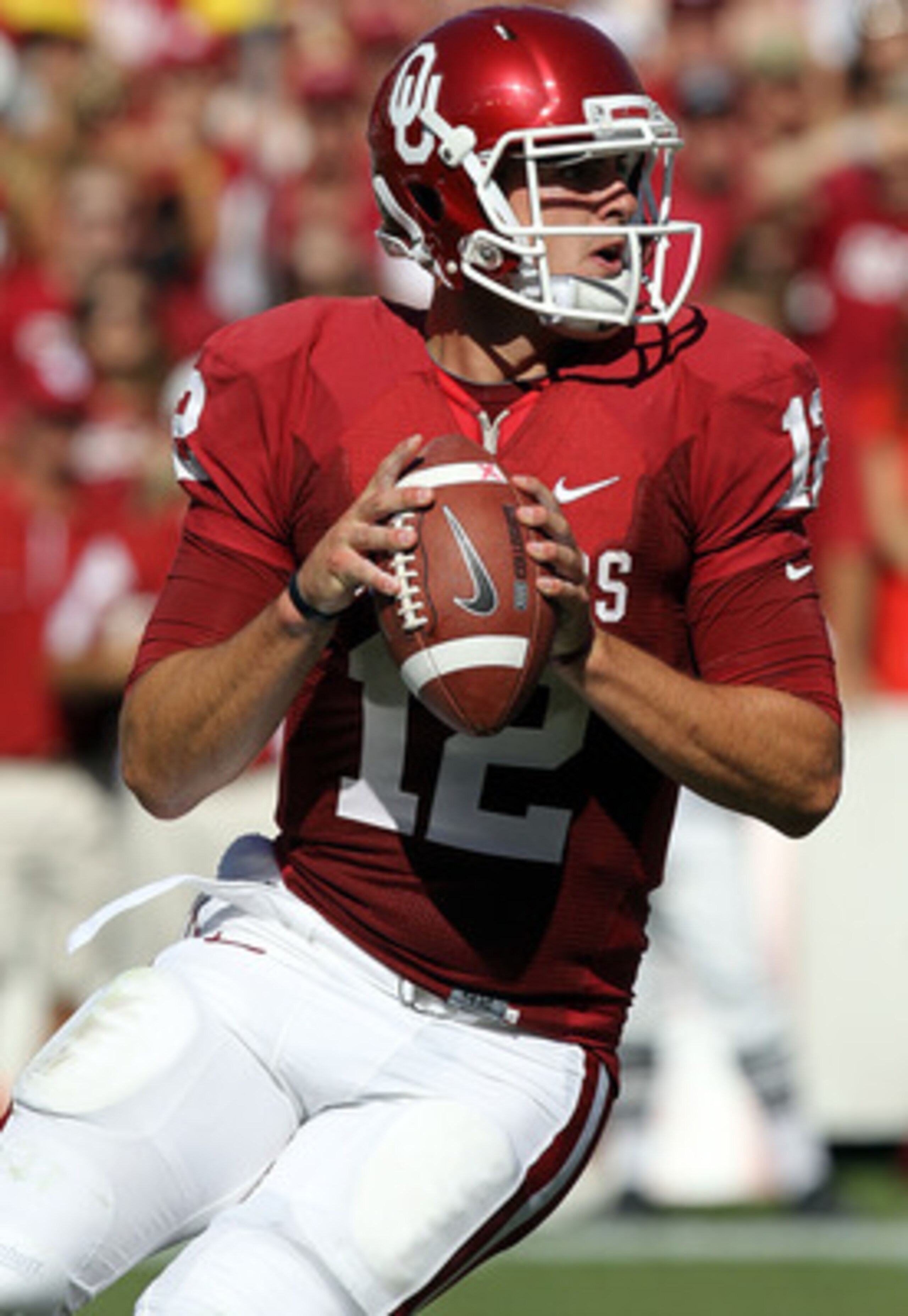 DALLAS - OCTOBER 02:  Quarterback Landry Jones #12 of the Oklahoma Sooners drops back to pass against the Texas Longhorns in the second quarter at the Cotton Bowl on October 2, 2010 in Dallas, Texas.  (Photo by Ronald Martinez/Getty Images)