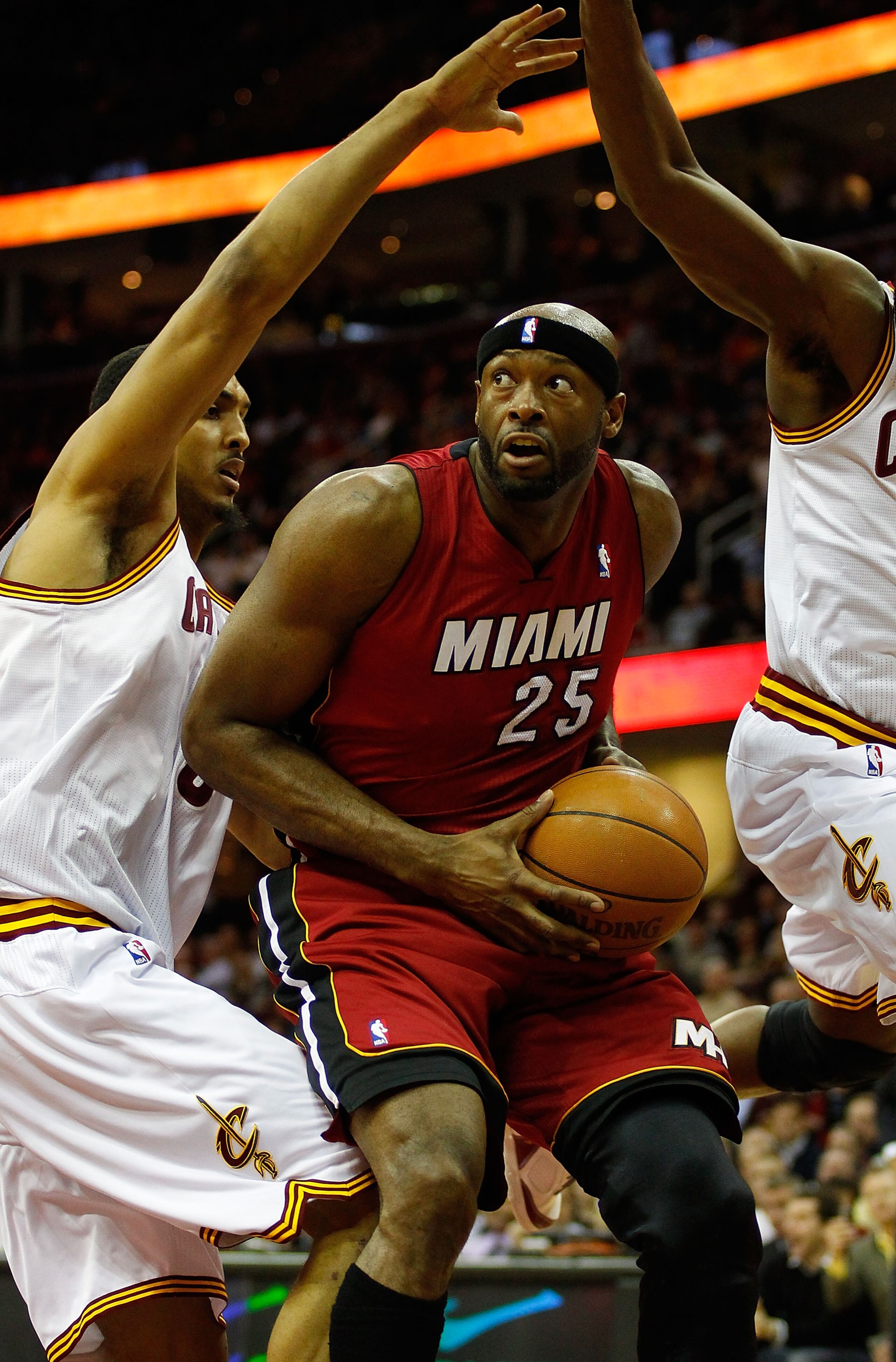 CLEVELAND - MARCH 29: Erick Dampier #25 of the Miami Heat is surrounded by Cleveland Cavaliers defenders during the game on March 29, 2011 at Quicken Loans Arena in Cleveland, Ohio. NOTE TO USER: User expressly acknowledges and agrees that, by downloading
