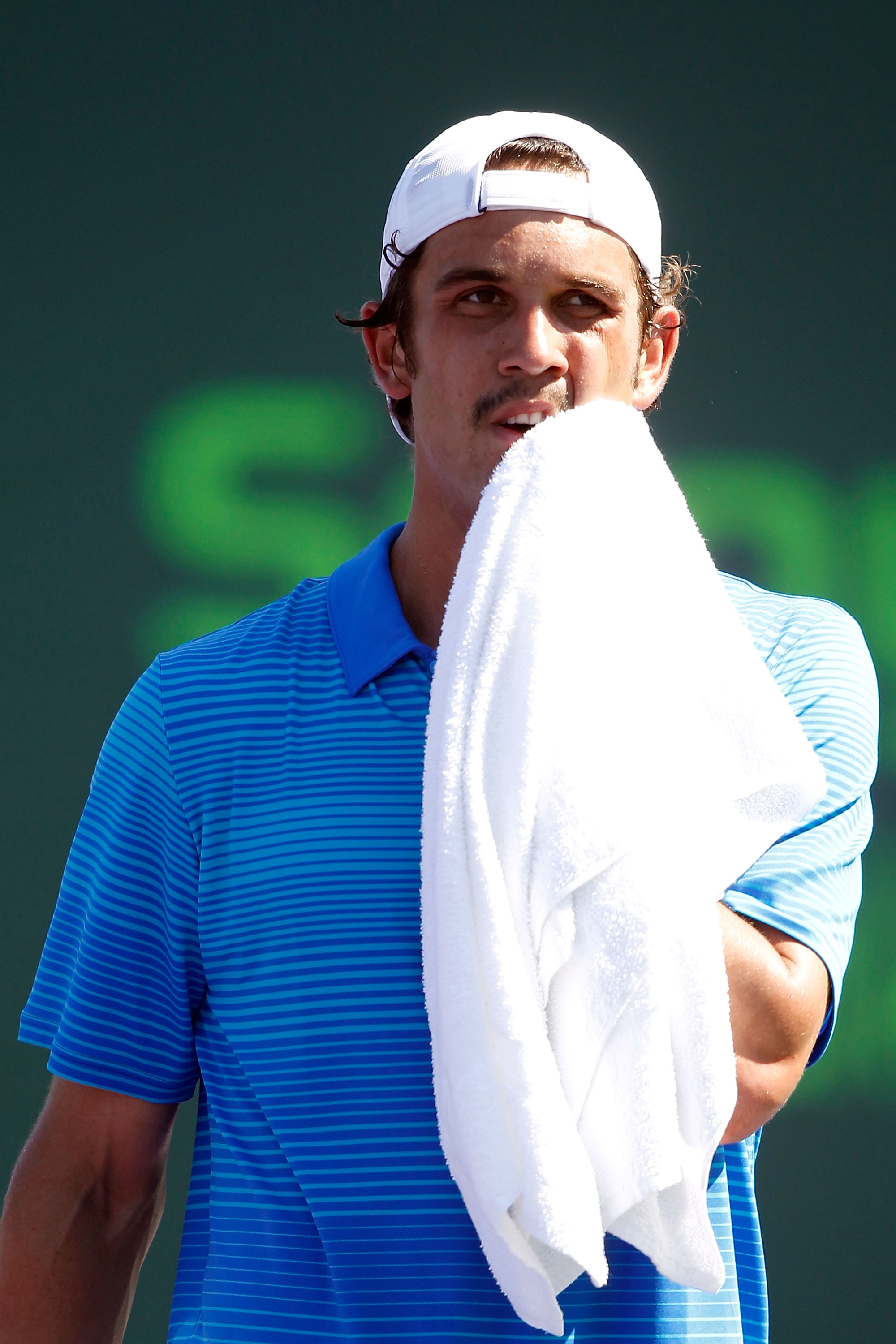 KEY BISCAYNE, FL - MARCH 23:  Ryan Sweeting wipes his face with a towel against Xavier Malisse of Belgium during the Sony Ericsson Open at Crandon Park Tennis Center on March 23, 2011 in Key Biscayne, Florida.  (Photo by Matthew Stockman/Getty Images)