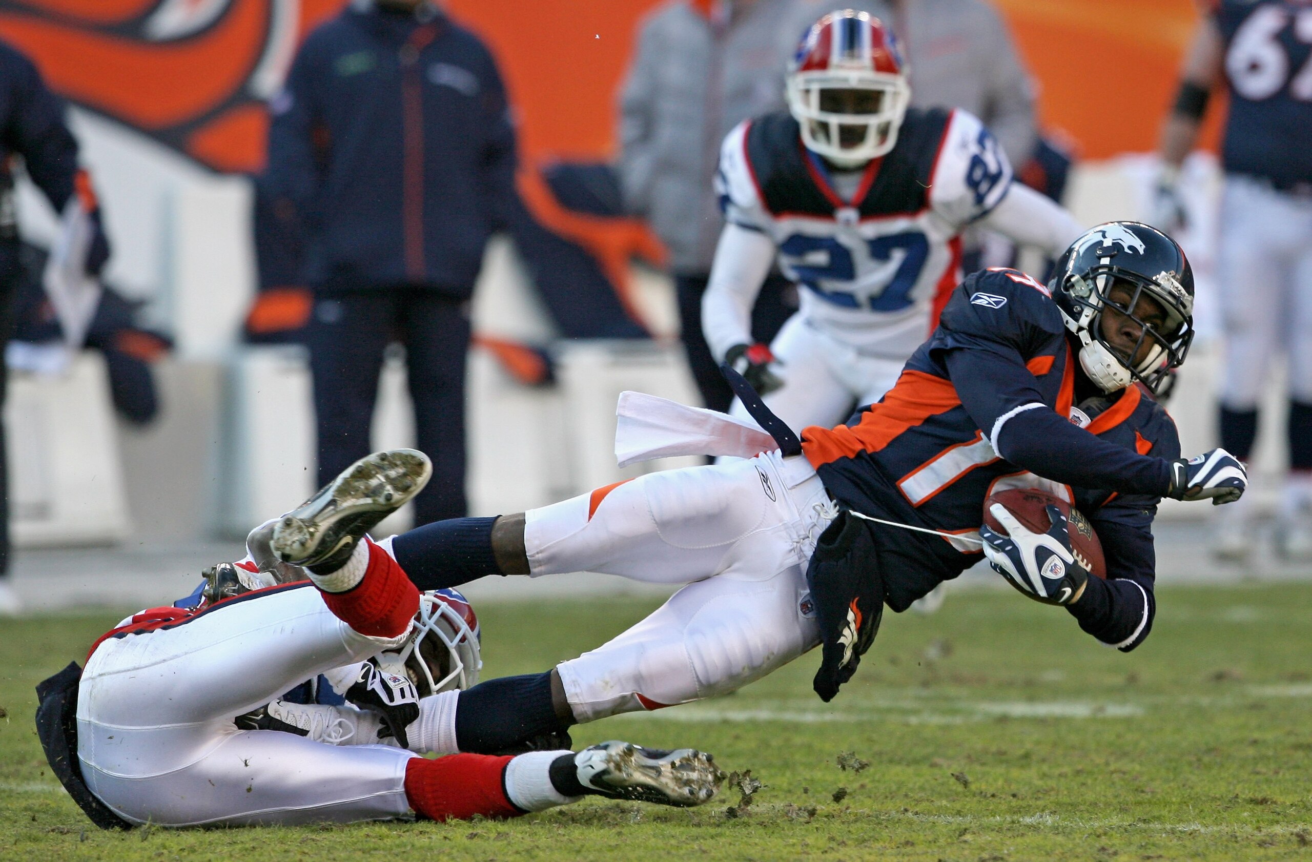DENVER - DECEMBER 21:  Wide receiver Eddie Royal #19 of the Denver Broncos makes a reception as cornerback Leodis McKelvin #28 of the Buffalo Bills makes the tackle during NFL action at Invesco Field at Mile High on December 21, 2008 in Denver, Colorado.