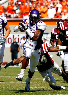 BLACKSBURG, VA - SEPTEMBER 18: Wide receiver Lance Lewis #88 of the East Carolina Pirates runs with the ball as linebacker Lyndell Gibson #44 and defensive tackle John Graves #91 of the Virginia Tech Hokies chase at Lane Stadium on September 18, 2010 in B