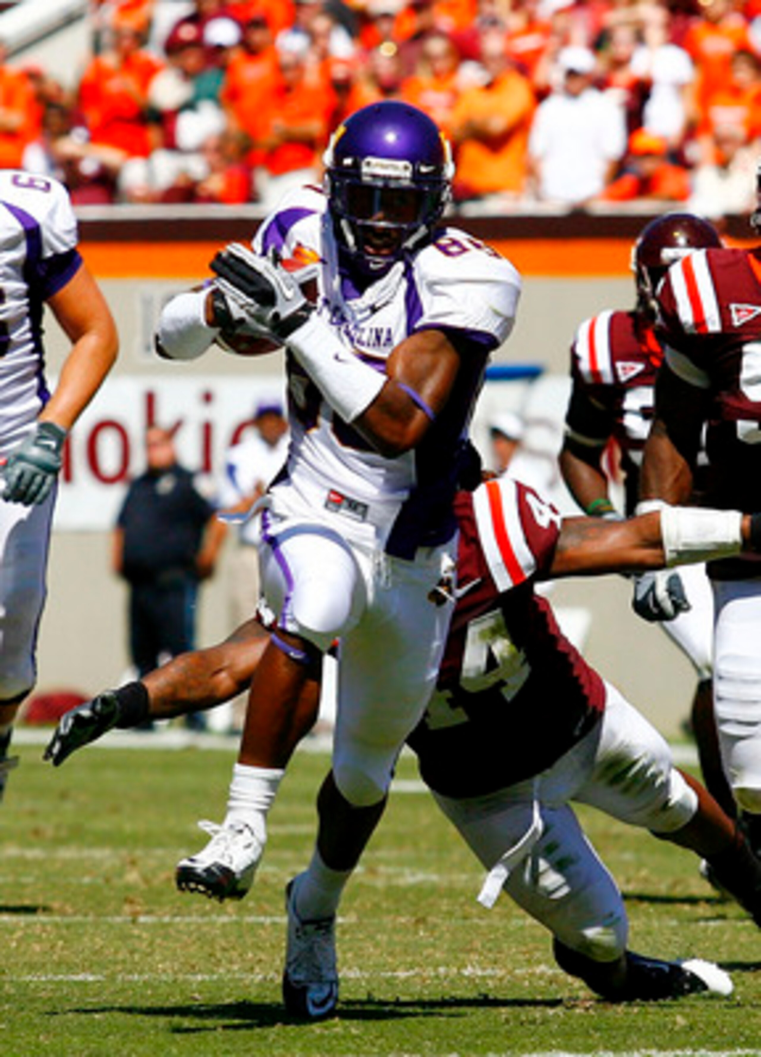 BLACKSBURG, VA - SEPTEMBER 18: Wide receiver Lance Lewis #88 of the East Carolina Pirates runs with the ball as linebacker Lyndell Gibson #44 and defensive tackle John Graves #91 of the Virginia Tech Hokies chase at Lane Stadium on September 18, 2010 in B