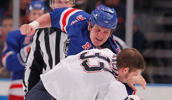 NEW YORK - NOVEMBER 14:  Steve MacIntyre #33 of the Edmonton Oilers fighting with Derek Boogaard #94 of the New York Rangers during a hockey game at Madison Square Garden on November 14, 2010 in New York City.  (Photo by Paul Bereswill/Getty Images)