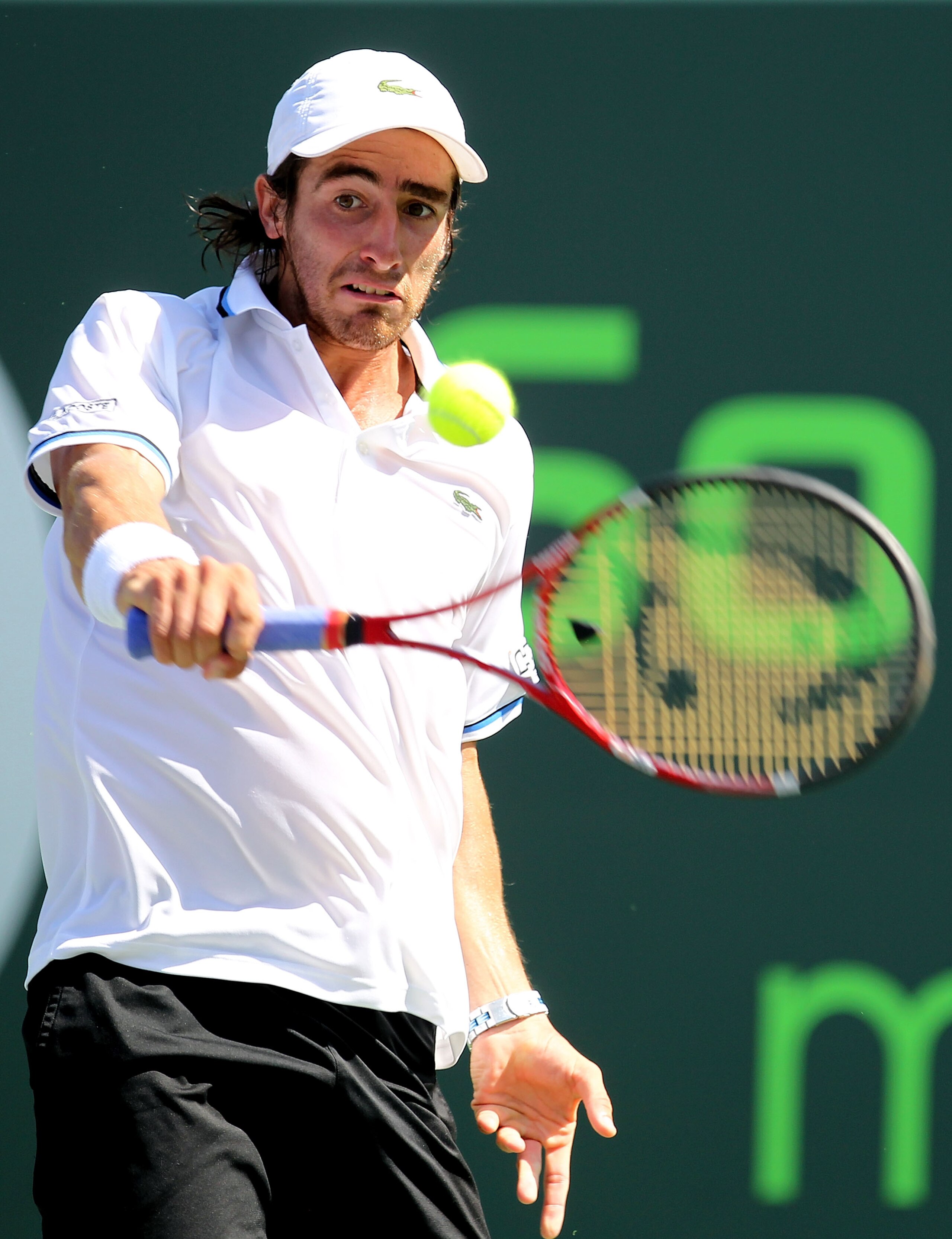 KEY BISCAYNE, FL - MARCH 26:  Pablo Cuevas of Uruguay hits a backhand return against Andy Roddick during the Sony Ericsson Open at Crandon Park Tennis Center on March 26, 2011 in Key Biscayne, Florida.  (Photo by Al Bello/Getty Images)