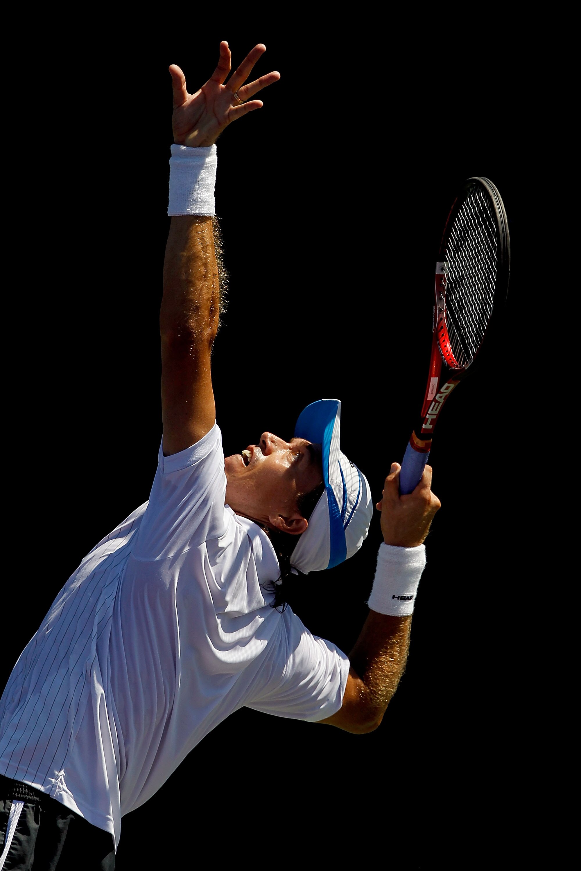 KEY BISCAYNE, FL - MARCH 26:  Carlos Berlocq of Argentina serves to Ernests Gulbis of Lativa during the Sony Ericsson Open at Crandon Park Tennis Center on March 26, 2011 in Key Biscayne, Florida.  (Photo by Matthew Stockman/Getty Images)