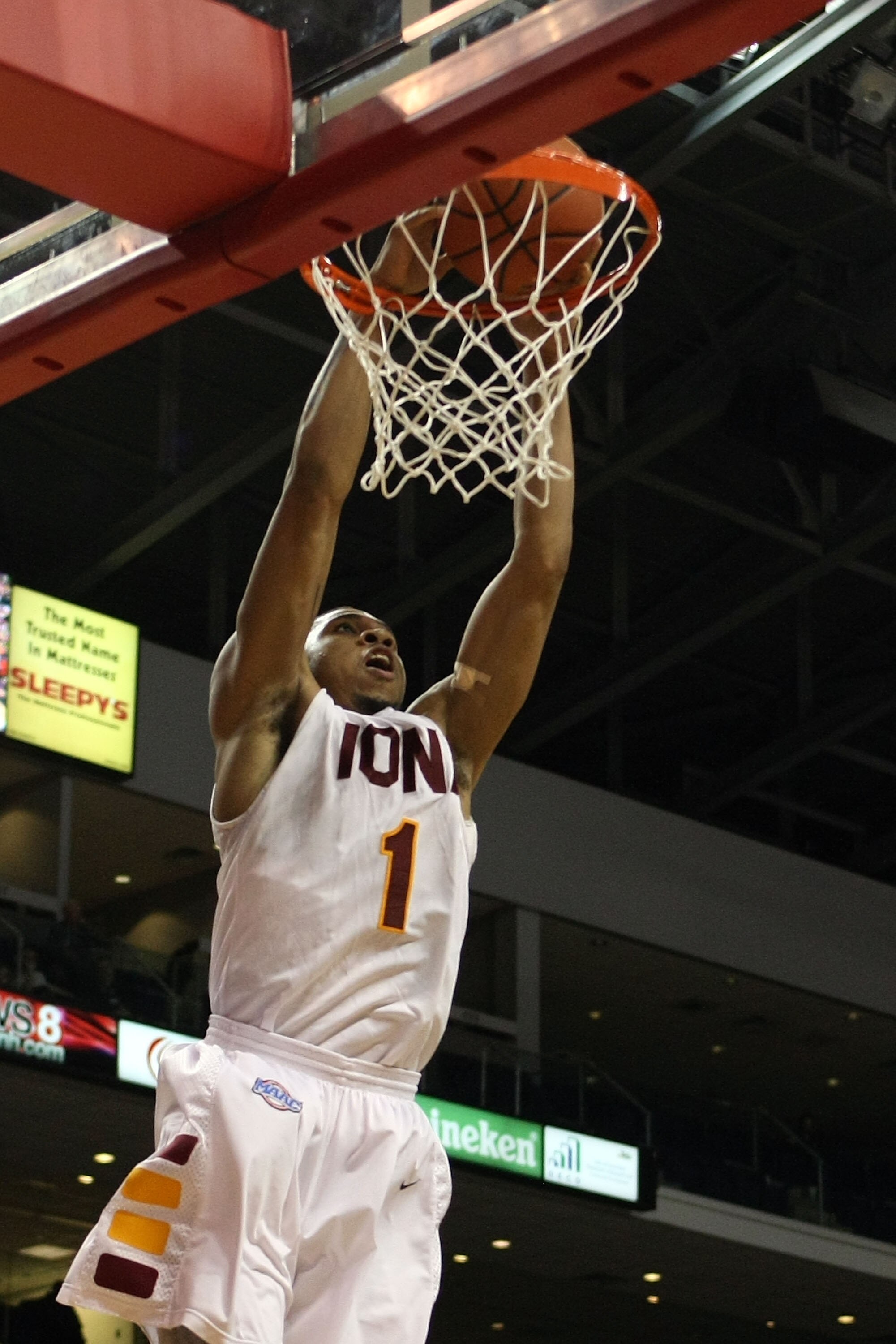 BRIDGEPORT, CT - MARCH 07:  Michael Glover #1 of the Iona Gaels dunks an alley-op pass against the St. Peter's Peacocks during the final of the MAAC men's conference basketball tournment at Webster Bank Arena at Harbor Yard on March 7, 2011 in Bridgeport,