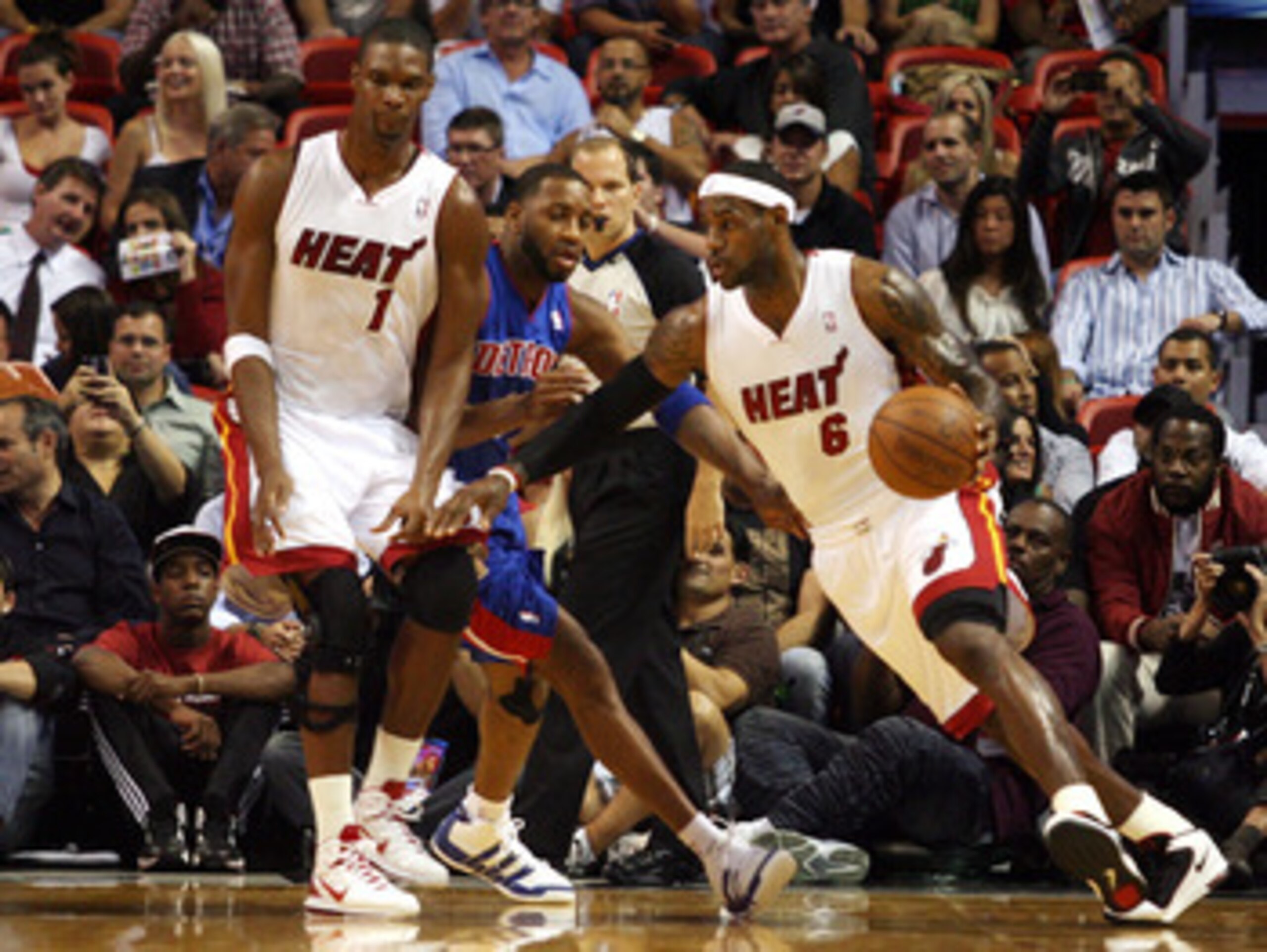 MIAMI - OCTOBER 05:  Center Chris Bosh #1 of the Miami Heat (L) sets a screen for teammate Lebron James #6 against the Detroit Pistons on October 5, 2010 in Miami, Florida.  NOTE TO USER: User expressly acknowledges and agrees that, by downloading and or