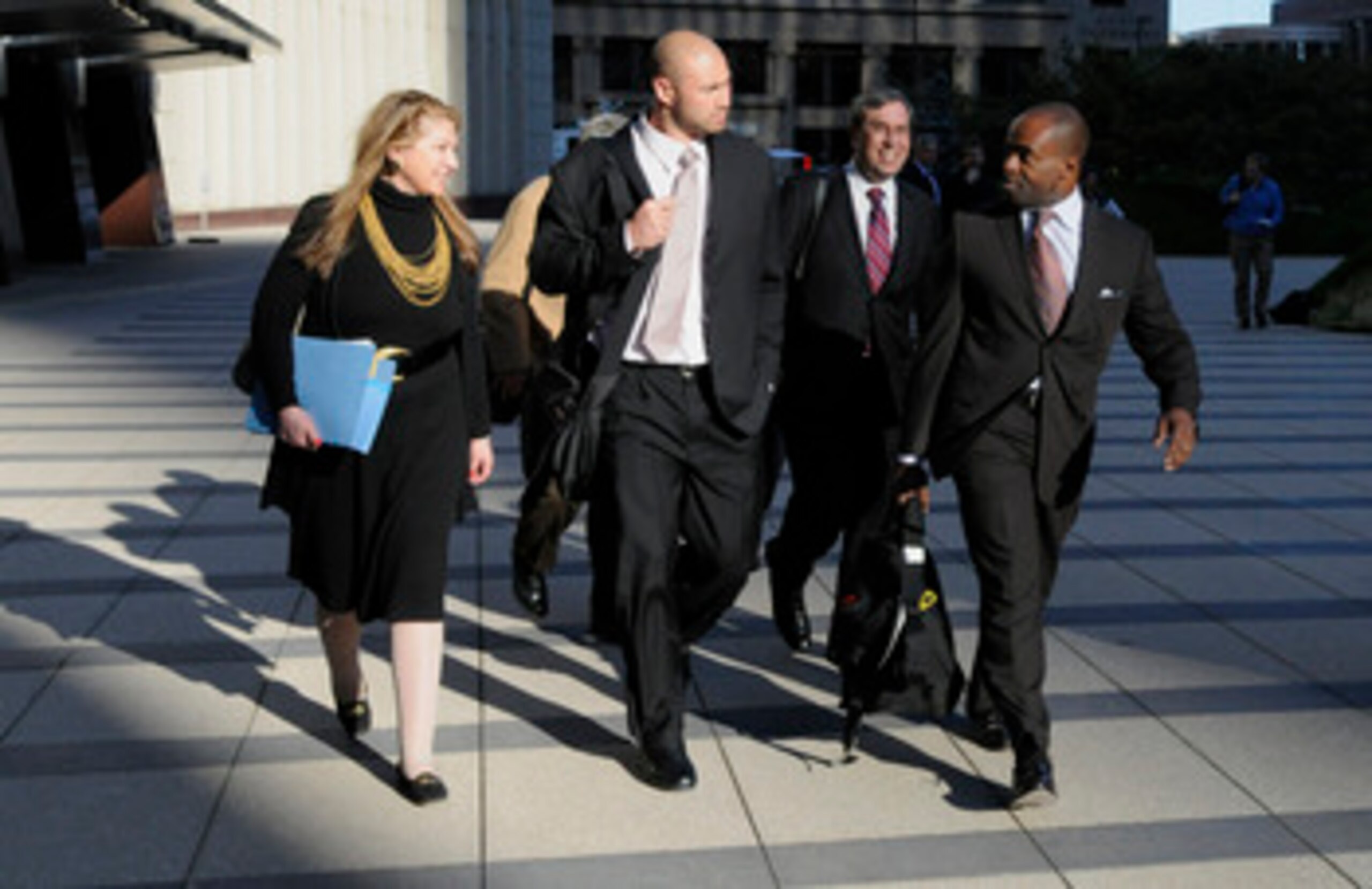 MINNEAPOLIS, MN - MAY 16: NFL players lawyer Barbara P. Berens (L), linebacker Ben Leber of the Minnesota Vikings, NFL players lawyer James Quinn and former NFL Players Association Executive Director DeMaurice Smith leave court-ordered mediation at the U.