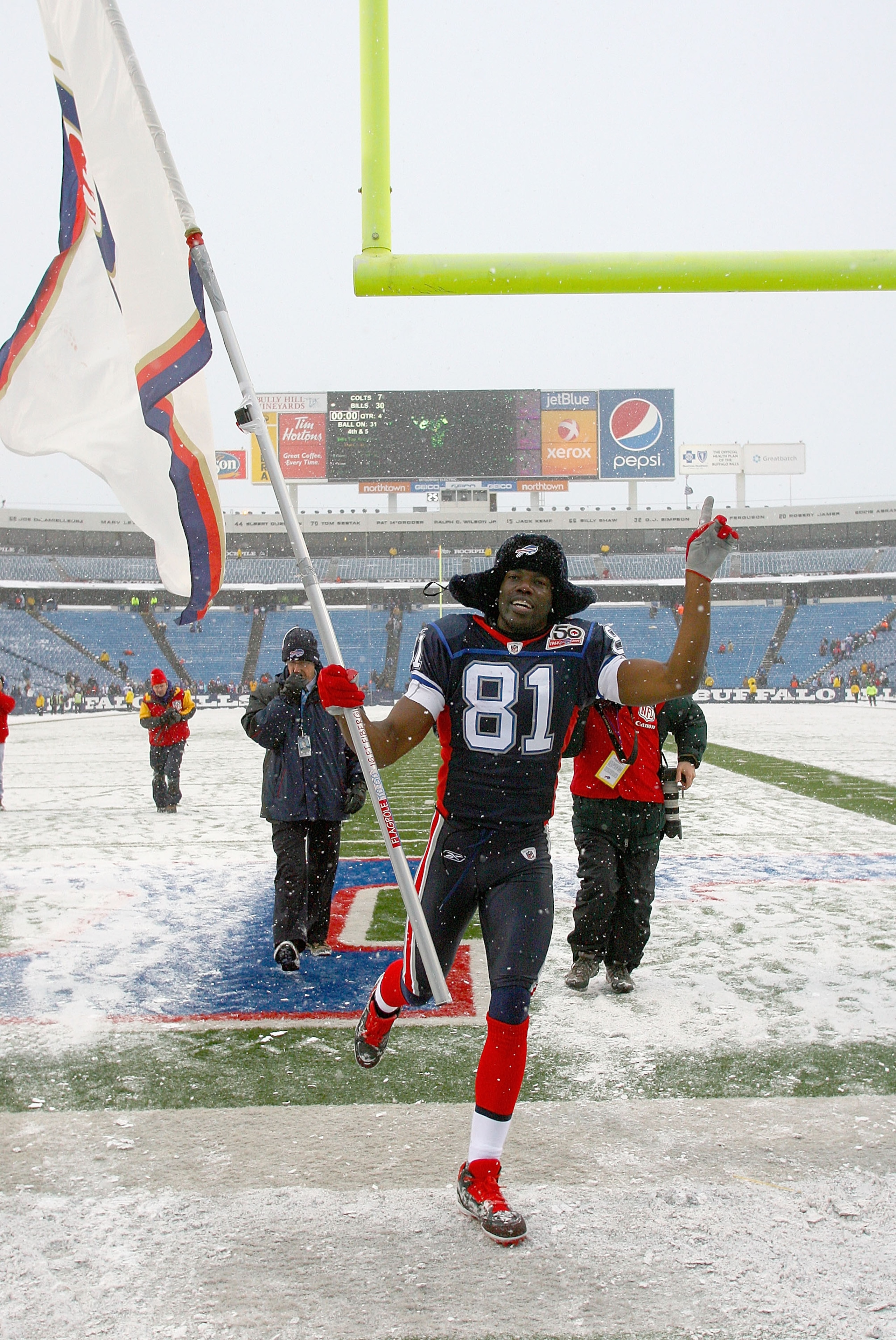 ORCHARD PARK, NY - JANUARY 03: Terrell Owens #81 of the Buffalo Bills runs off the field with a Bills flag after the Bills defeated the Indianapolis Colts at Ralph Wilson Stadium on January 3, 2010 in Orchard Park, New York. Buffalo won 30-7. (Photo by Ri