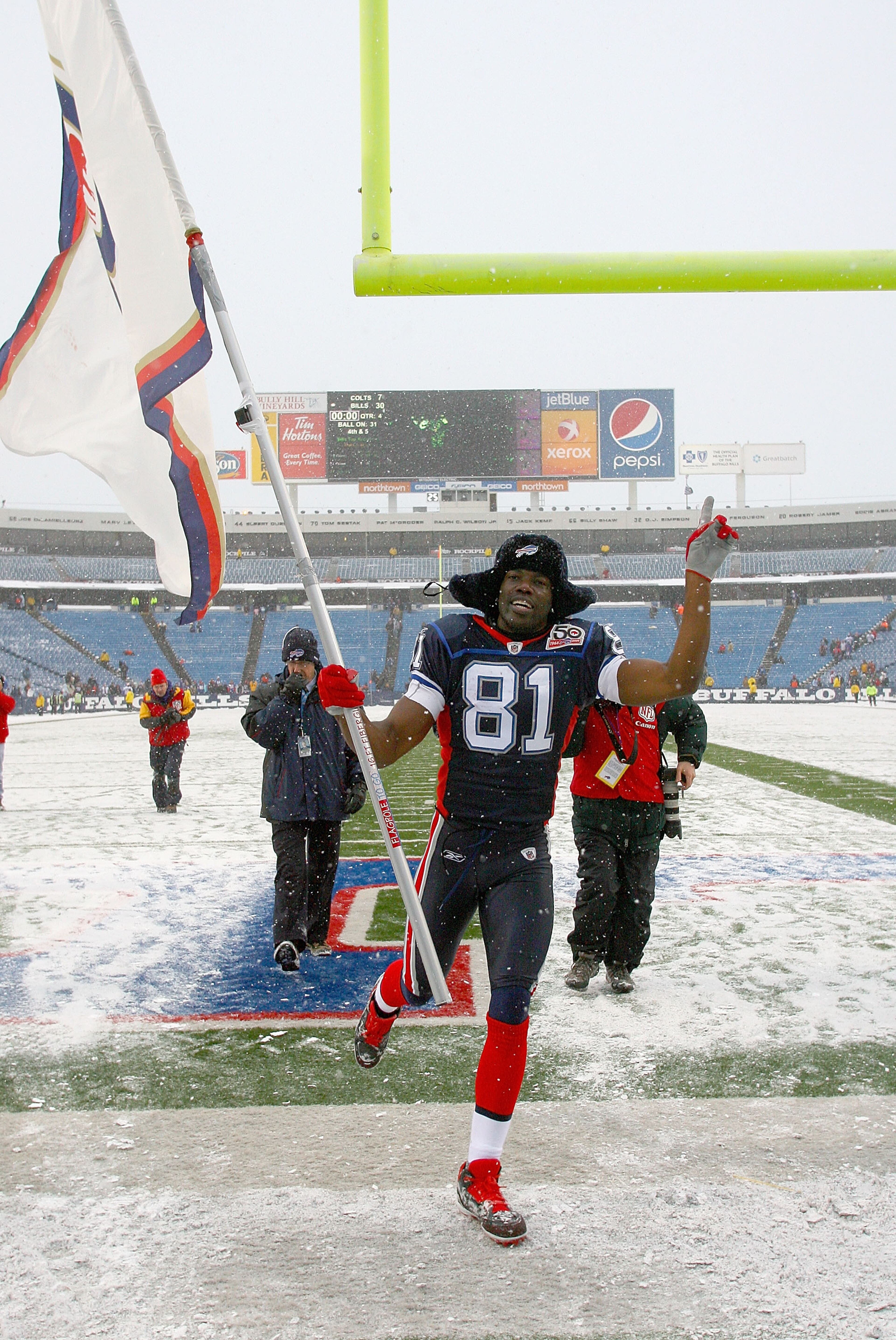 ORCHARD PARK, NY - JANUARY 03: Terrell Owens #81 of the Buffalo Bills runs off the field with a Bills flag after the Bills defeated the Indianapolis Colts at Ralph Wilson Stadium on January 3, 2010 in Orchard Park, New York. Buffalo won 30-7. (Photo by Ri