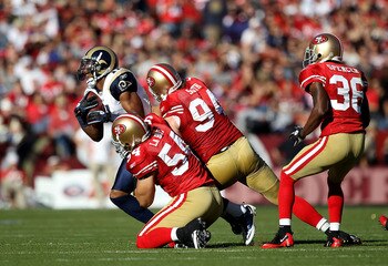 SAN FRANCISCO - NOVEMBER 14:  Brandon Gibson #11 of the St. Louis Rams is tackled by Travis LaBoy #54 and Justin Smith #94 of the San Francisco 49ers at Candlestick Park on November 14, 2010 in San Francisco, California.  (Photo by Ezra Shaw/Getty Images)