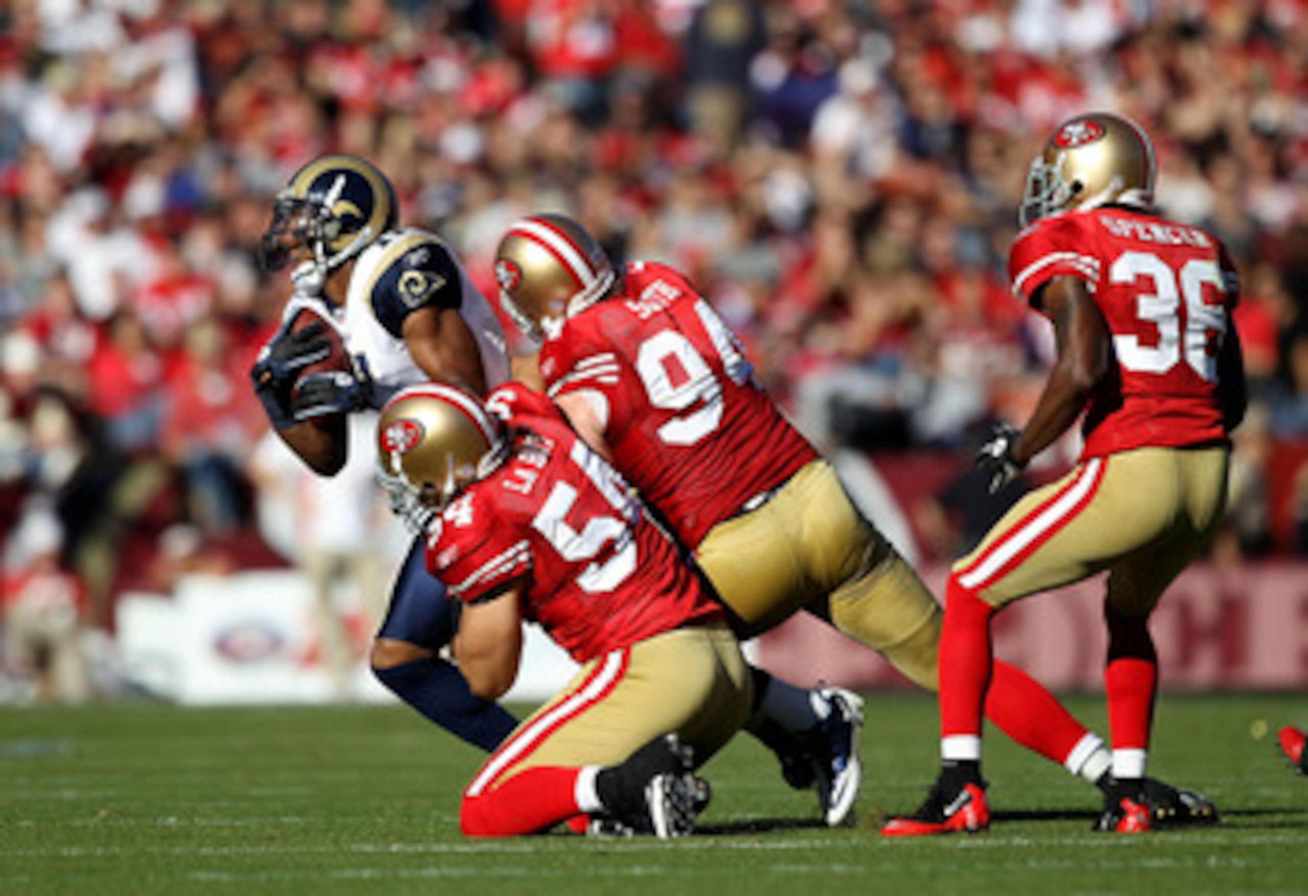 SAN FRANCISCO - NOVEMBER 14:  Brandon Gibson #11 of the St. Louis Rams is tackled by Travis LaBoy #54 and Justin Smith #94 of the San Francisco 49ers at Candlestick Park on November 14, 2010 in San Francisco, California.  (Photo by Ezra Shaw/Getty Images)