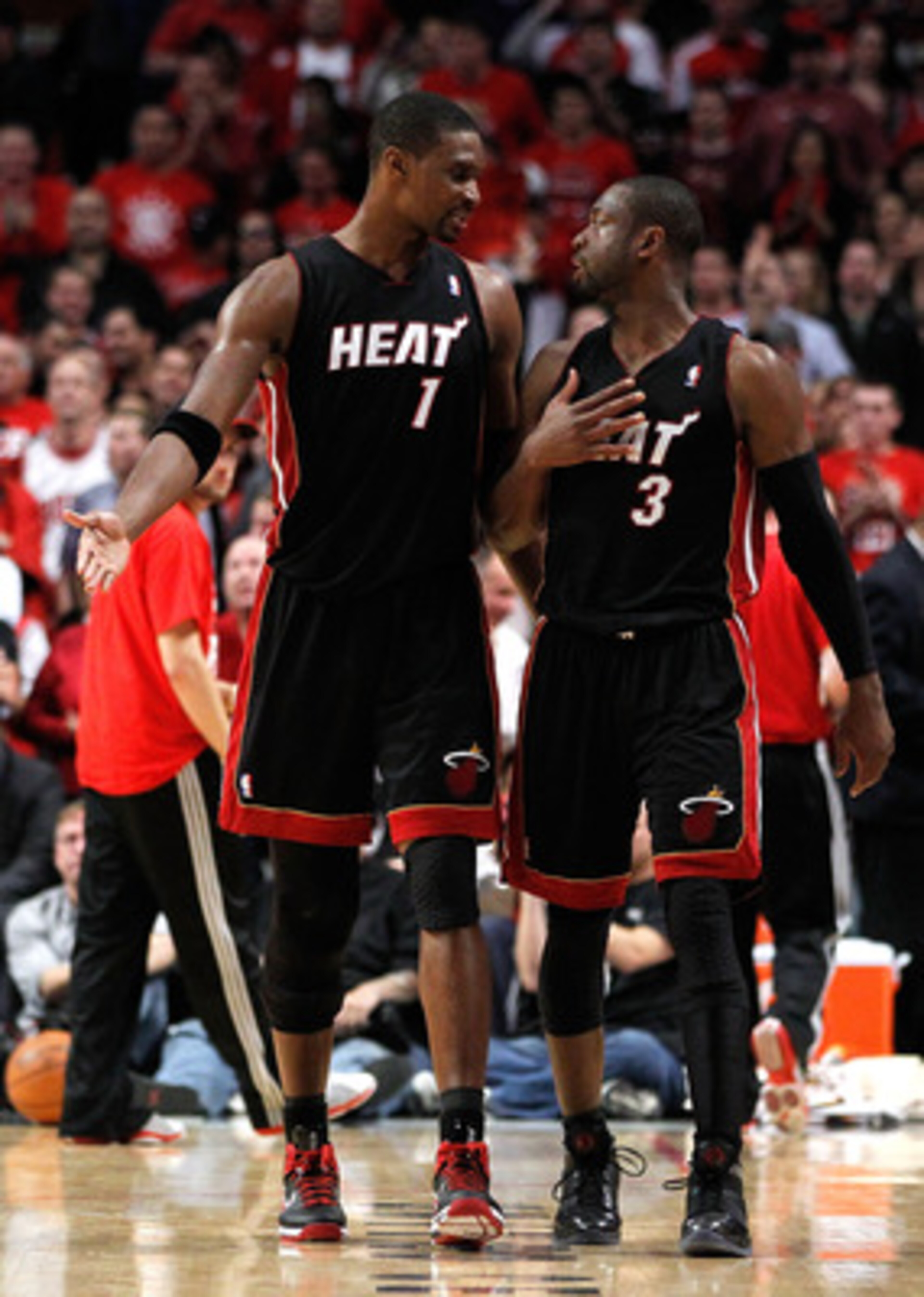 CHICAGO, IL - MAY 15: (L-R) Chris Bosh #1 and Dwyane Wade #3 of the Miami Heat talk on court against the Miami Heat in Game One of the Eastern Conference Finals during the 2011 NBA Playoffs on May 15, 2011 at the United Center in Chicago, Illinois. NOTE T