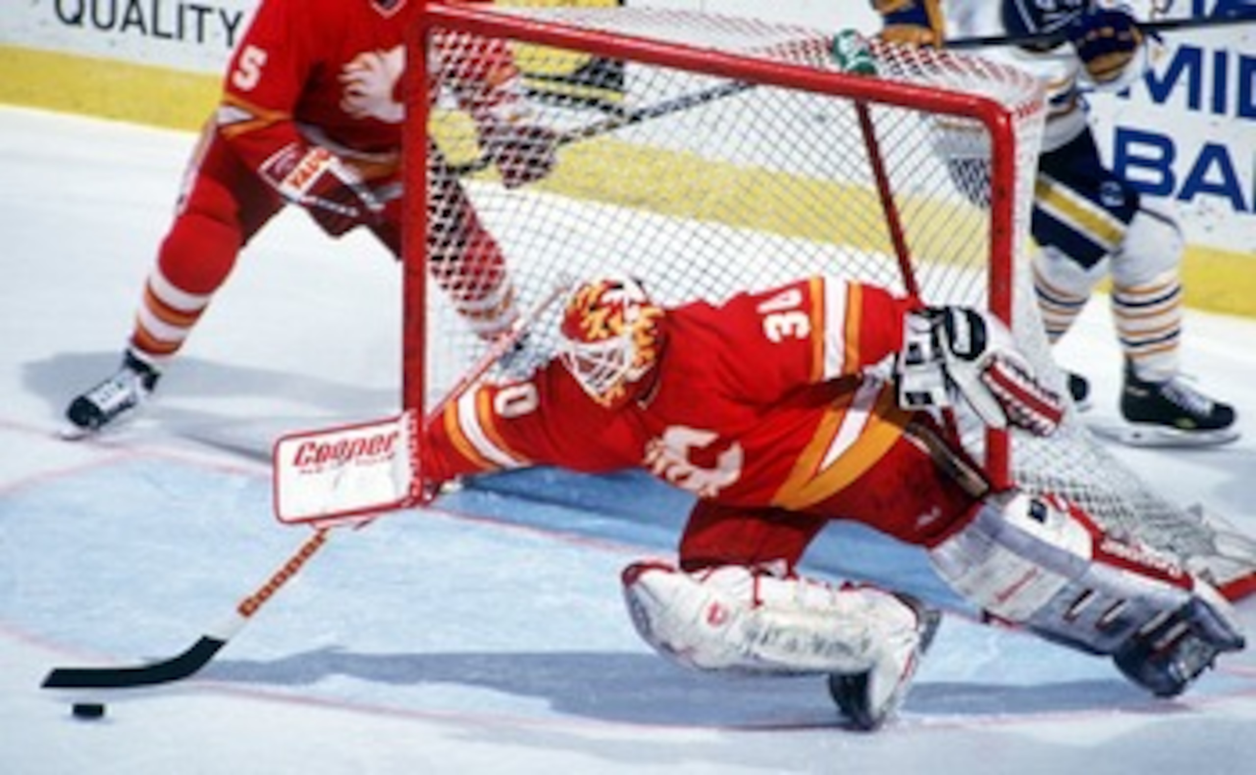 1994:  GOAL KEEPER MIKE VERNON OF THE CALGARY FLAMES REACHES WITH HIS STICK FOR THE LOOSE PUCK DURING THE FLAMES GAME AT THE BUFFALO SABRES DURING THE 1993-94 REGULAR SEASON. Mandatory Credit: Rick Stewart/ALLSPORT