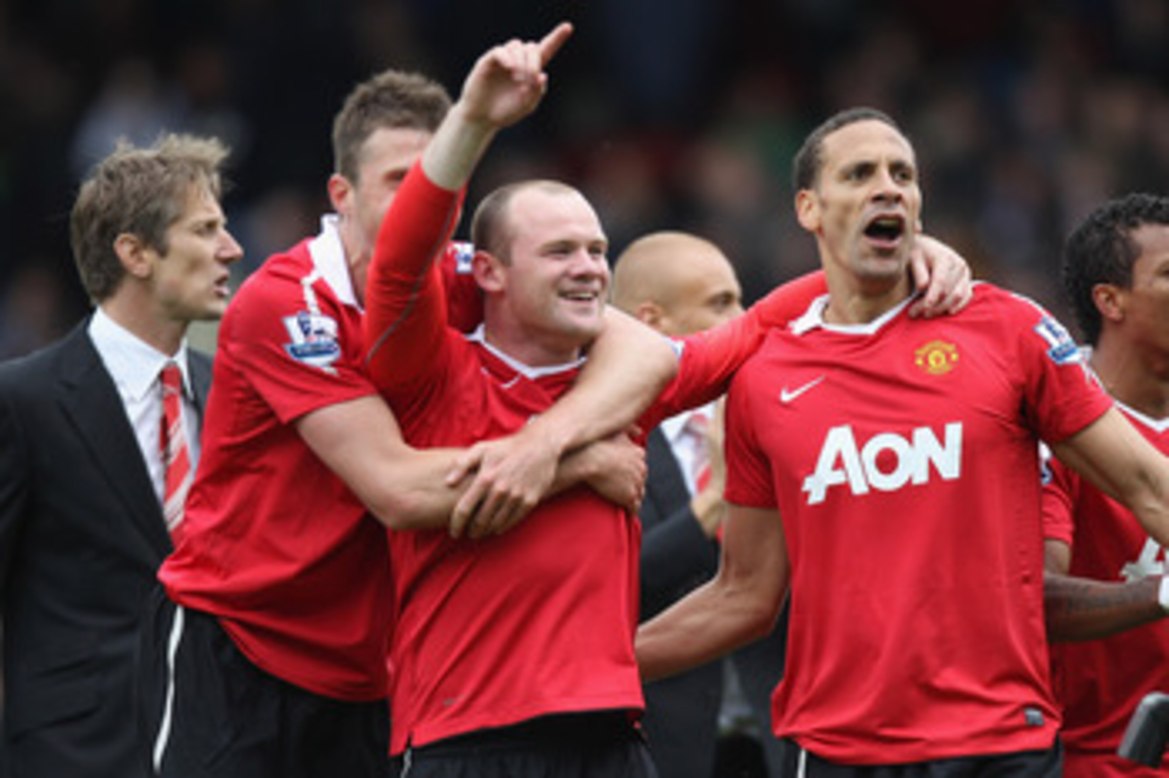 BLACKBURN, ENGLAND - MAY 14:  Michael Carrick (L), Wayne Rooney (C) and Rio Ferdinand of Manchester United celebrate clinching the title during the Barclays Premier League match between Blackburn Rovers and Manchester United at Ewood Park on May 14, 2011 