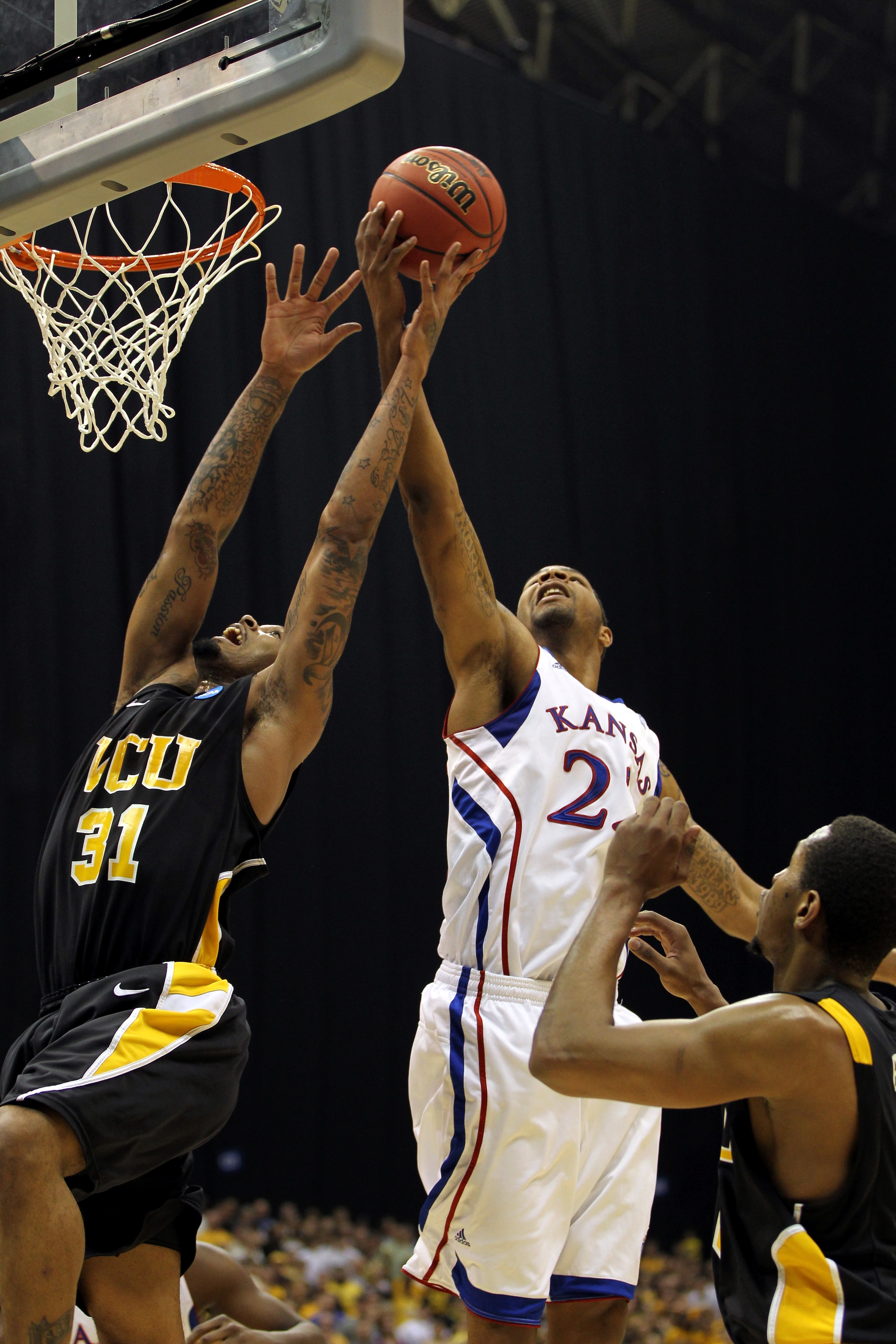 SAN ANTONIO, TX - MARCH 27:  Marcus Morris #22 of the Kansas Jayhawks grabs the rebound against Toby Veal #31 of the Virginia Commonwealth Rams during the southwest regional final of the 2011 NCAA men's basketball tournament at the Alamodome on March 27,