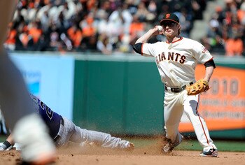 SAN FRANCISCO, CA - MAY 8: Mike Fontenot #14 of the San Francisco Giants gets his throw off to complete the double-play, avoiding the slide of Troy Tulowitzki #2 of the Colorado Rockies during a MLB baseball game at AT&T Park May 8, 2011 in San Francisco,