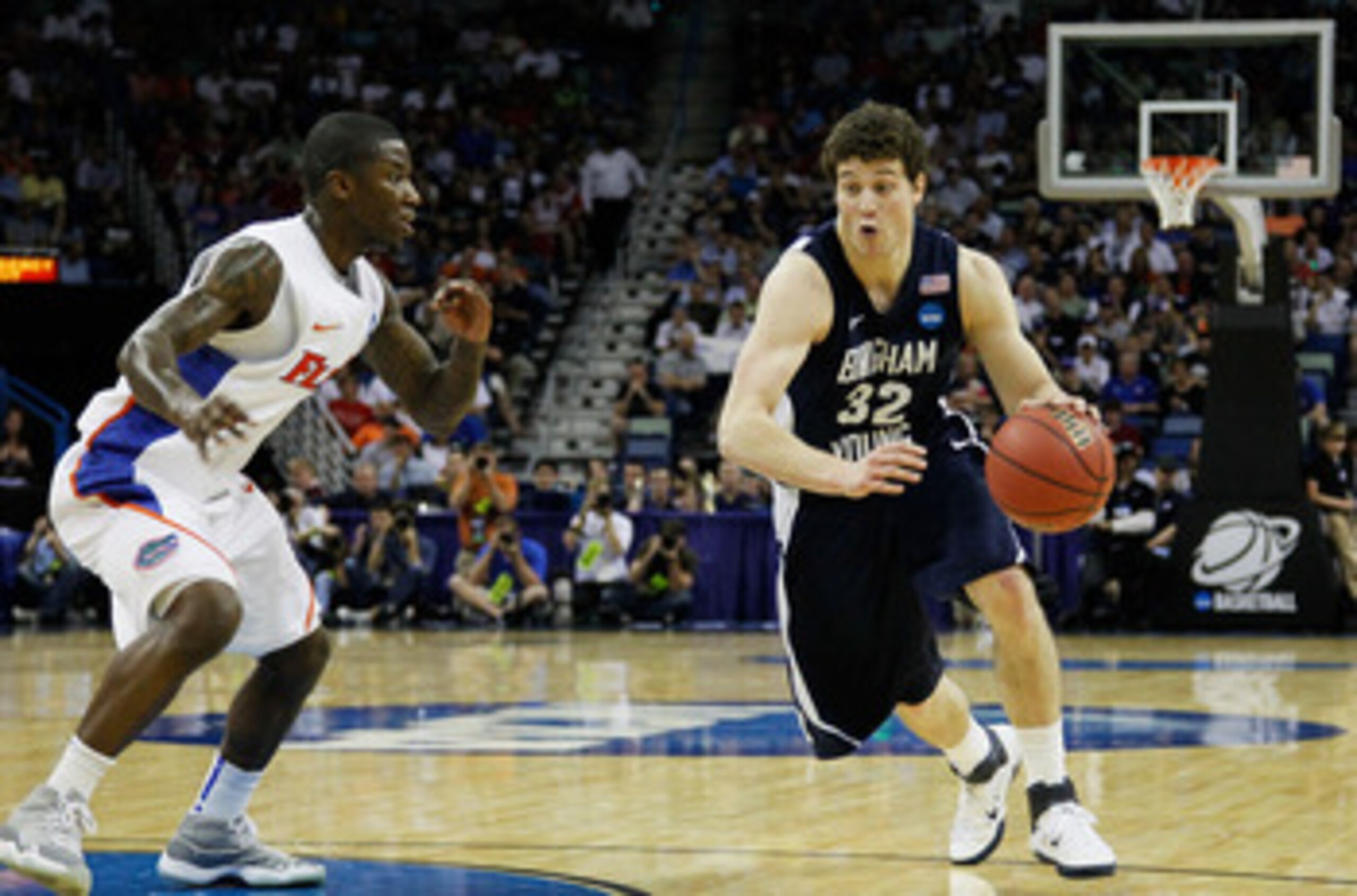 NEW ORLEANS, LA - MARCH 24:  Jimmer Fredette #32 of the Brigham Young Cougars drives past Kenny Boynton #1 of the Florida Gators during the Southeast regional of the 2011 NCAA men's basketball tournament at New Orleans Arena on March 24, 2011 in New Orlea