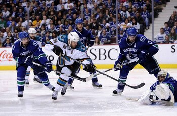 VANCOUVER, CANADA - MAY 15:  Goaltender Roberto Luongo #1 of the Vancouver Canucks makes a save on a backhand shot by Joe Thornton #19 of the San Jose Sharks as Ryan Kesler #17 and Dan Hamhuis #2 of the Vancouver Canucks look on in Game One of the Western