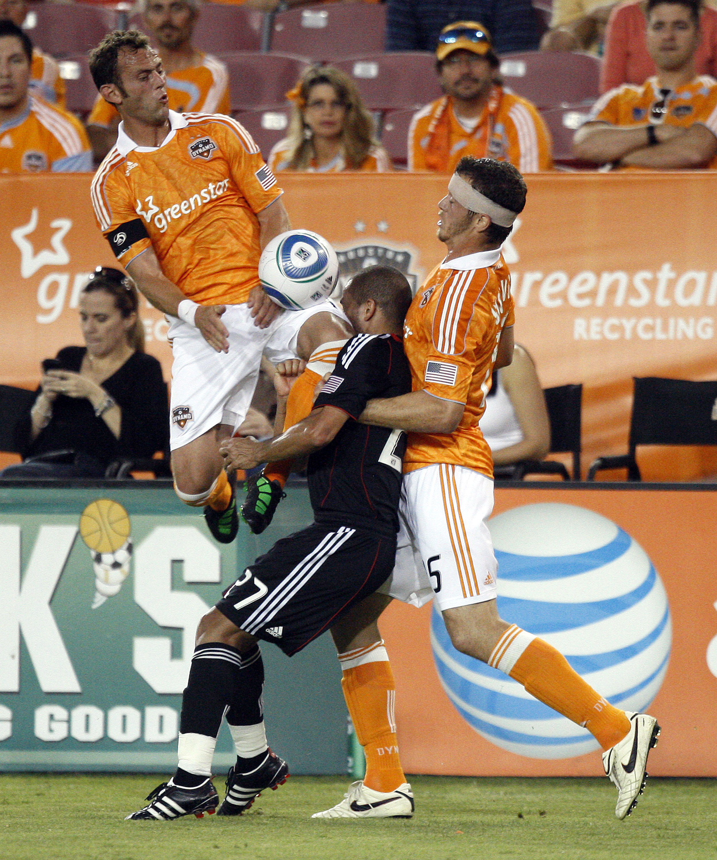 HOUSTON - APRIL 29:  Fred #27 of D.C.United takes a knee to the face from Brad Davis #11 of the Houston Dynamo as he goes for the ball with Cam Weaver #15 of the Houston Dynamo in the first half at Robertson Stadium on April 29, 2011 in Houston, Texas.  (