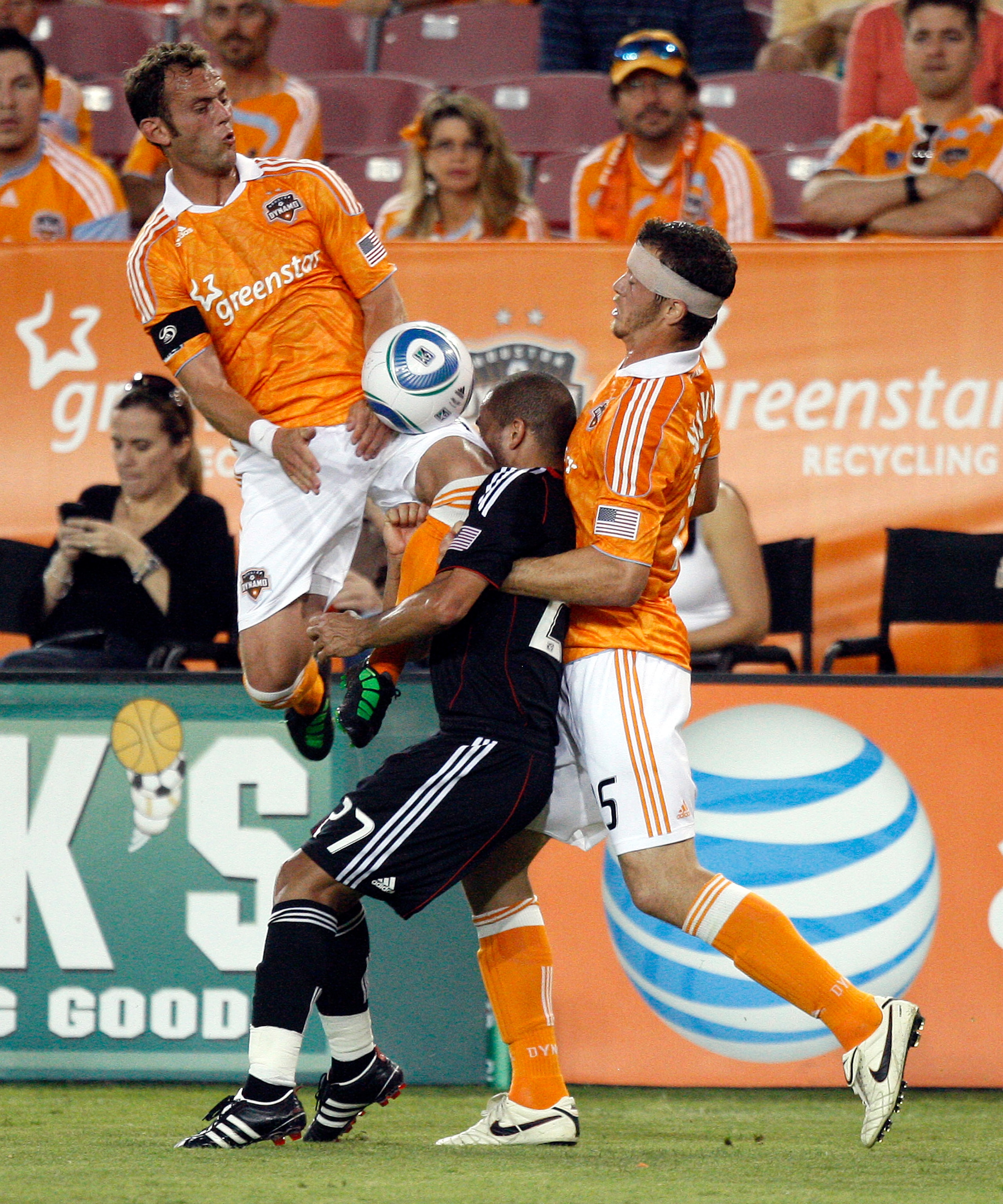 HOUSTON - APRIL 29:  Fred #27 of D.C.United takes a knee to the face from Brad Davis #11 of the Houston Dynamo as he goes for the ball with Cam Weaver #15 of the Houston Dynamo in the first half at Robertson Stadium on April 29, 2011 in Houston, Texas.  (