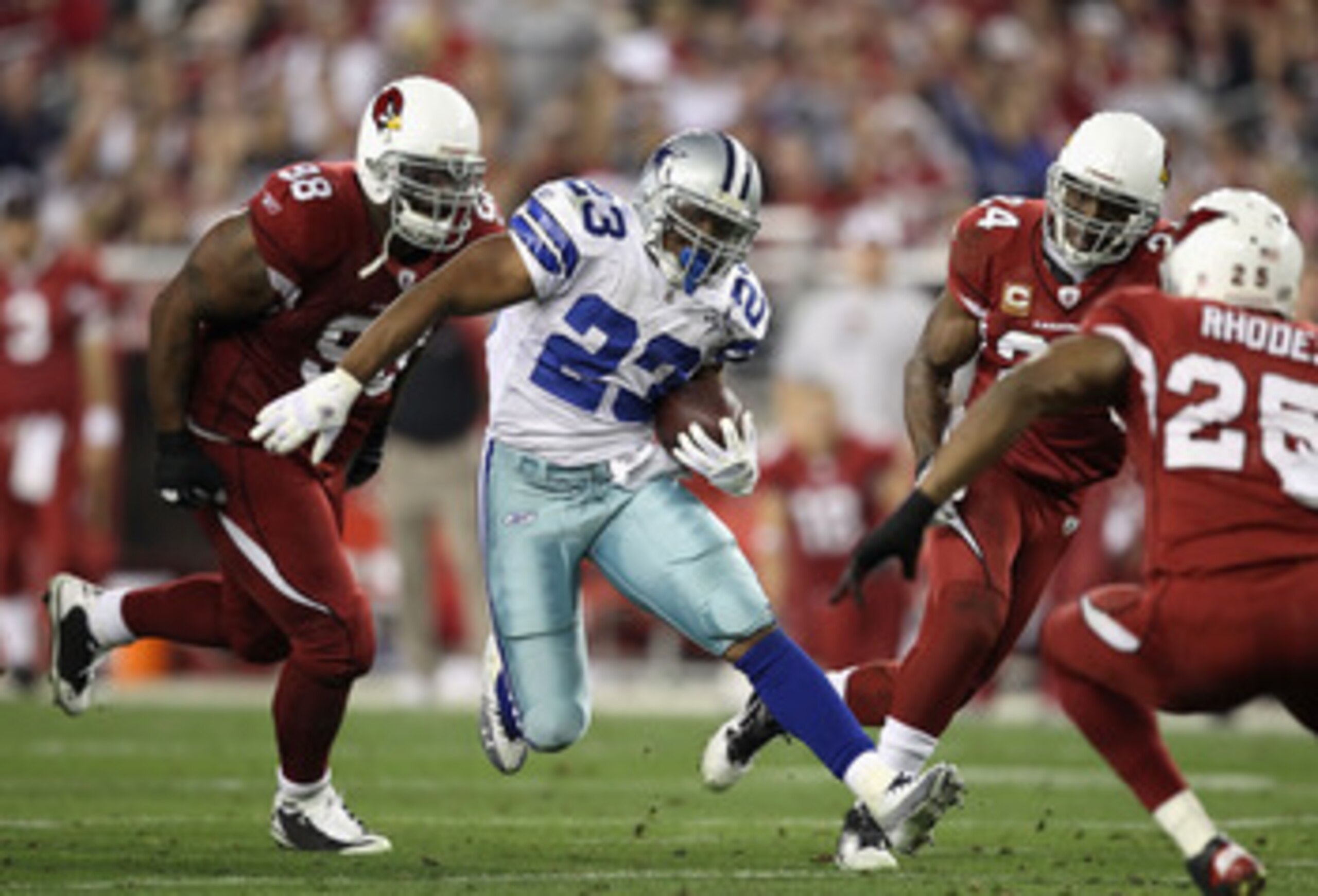 GLENDALE, AZ - DECEMBER 25: Runningback Tashard Choice #23 of the Dallas Cowboys rushes the football past Gabe Watson #98 of the Arizona Cardinals during the NFL game at the University of Phoenix Stadium on December 25, 2010 in Glendale, Arizona. The Car GLENDALE, AZ - DECEMBER 25: Runningback Tashard Choice #23 of the Dallas Cowboys rushes the football past Gabe Watson #98 of the Arizona Cardinals during the NFL game at the University of Phoenix Stadium on December 25, 2010 in Glendale, Arizona. The Car