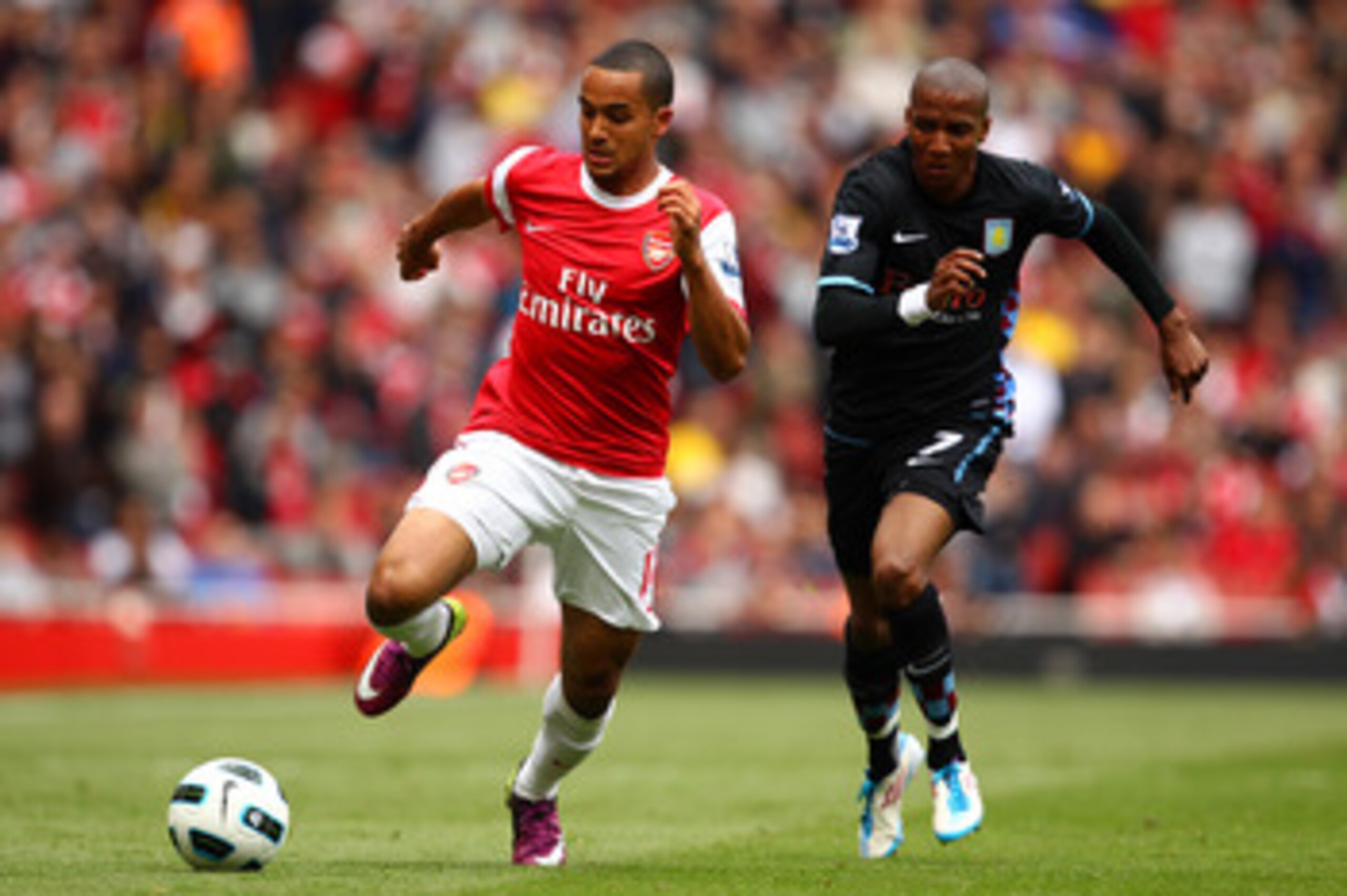 LONDON, ENGLAND - MAY 15:  Theo Walcott (L) of Arsenal in action against Ashley Young of Aston Villa during the Barclays Premier League match between Arsenal and Aston Villa at the Emirates Stadium on May 15, 2011 in London, England.  (Photo by Richard He