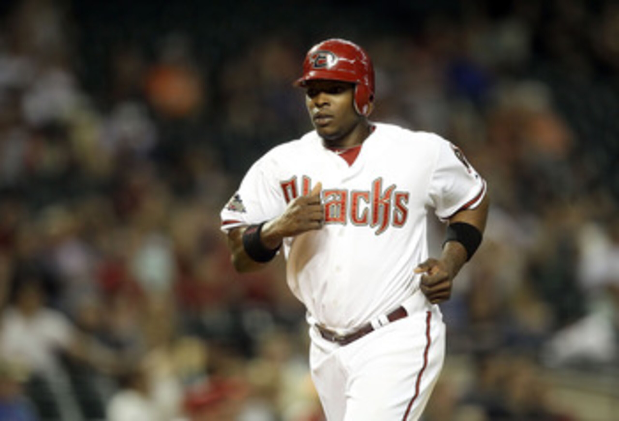 PHOENIX, AZ - MAY 17:  Justin Upton #10 of the Arizona Diamondbacks comes in to score a run against the San Diego Padres during the seventh inning of the Major League Baseball game at Chase Field on May 17, 2011 in Phoenix, Arizona.  (Photo by Christian P