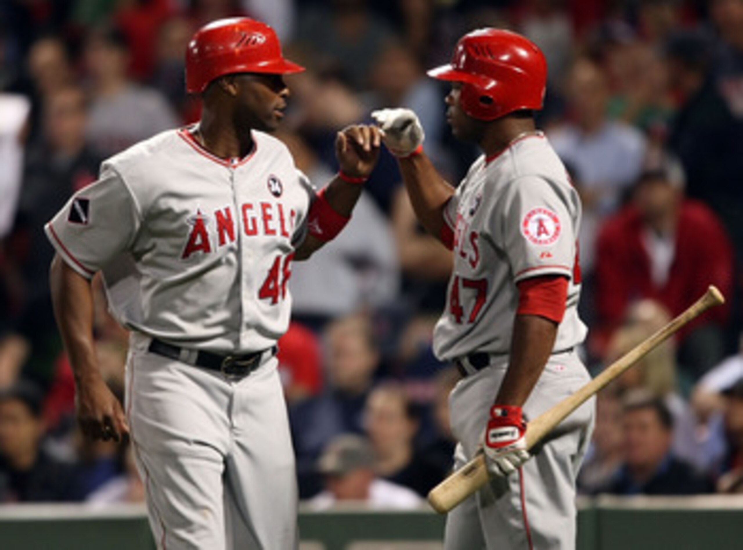 BOSTON - SEPTEMBER 15:  Torii Hunter #468 of the Los Angeles Angels of Anaheim is congratulated by teammate Howie Kendrick #47 after Hunter scored a run in the ninth inning against the Boston Red Sox on September 15, 2009 at Fenway Park in Boston, Massach
