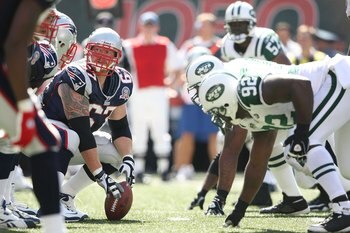 EAST RUTHERFORD, NJ - SEPTEMBER 20:  Dan Koppen #67 of the New England Patriots prepares to snap against the New York Jets at Giants Stadium on September 20, 2009 in East Rutherford, New Jersey.  (Photo by Nick Laham/Getty Images)