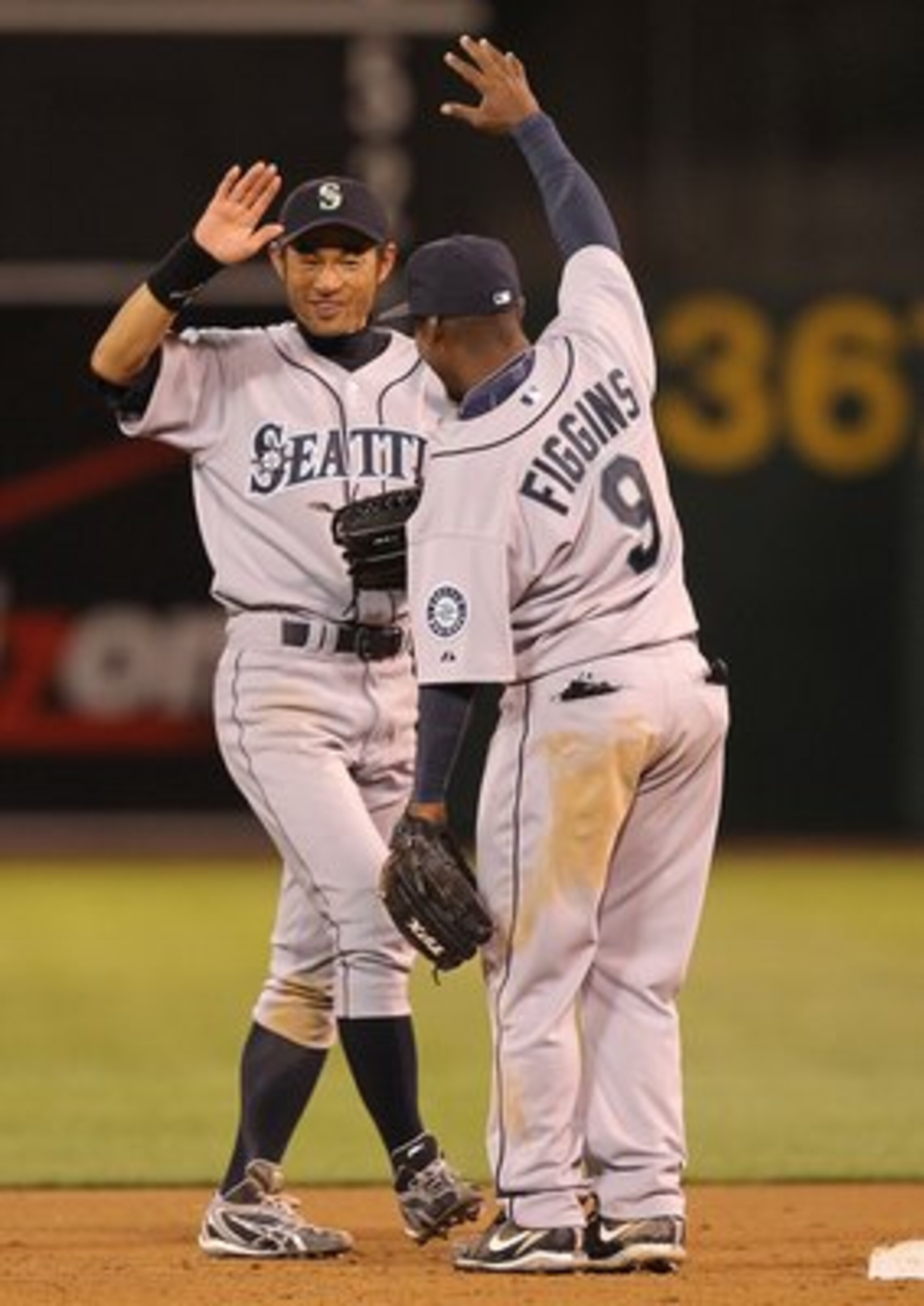 OAKLAND, CA - APRIL 05:  Ichiro Suzuki #51 of the Seattle Mariners celebrates with Chone Figgins after defeating the Oakland Athletics on Opening Day at the Oakland-Alameda County Coliseum on April 5, 2010 in Oakland, California.  (Photo by Jed Jacobsohn/