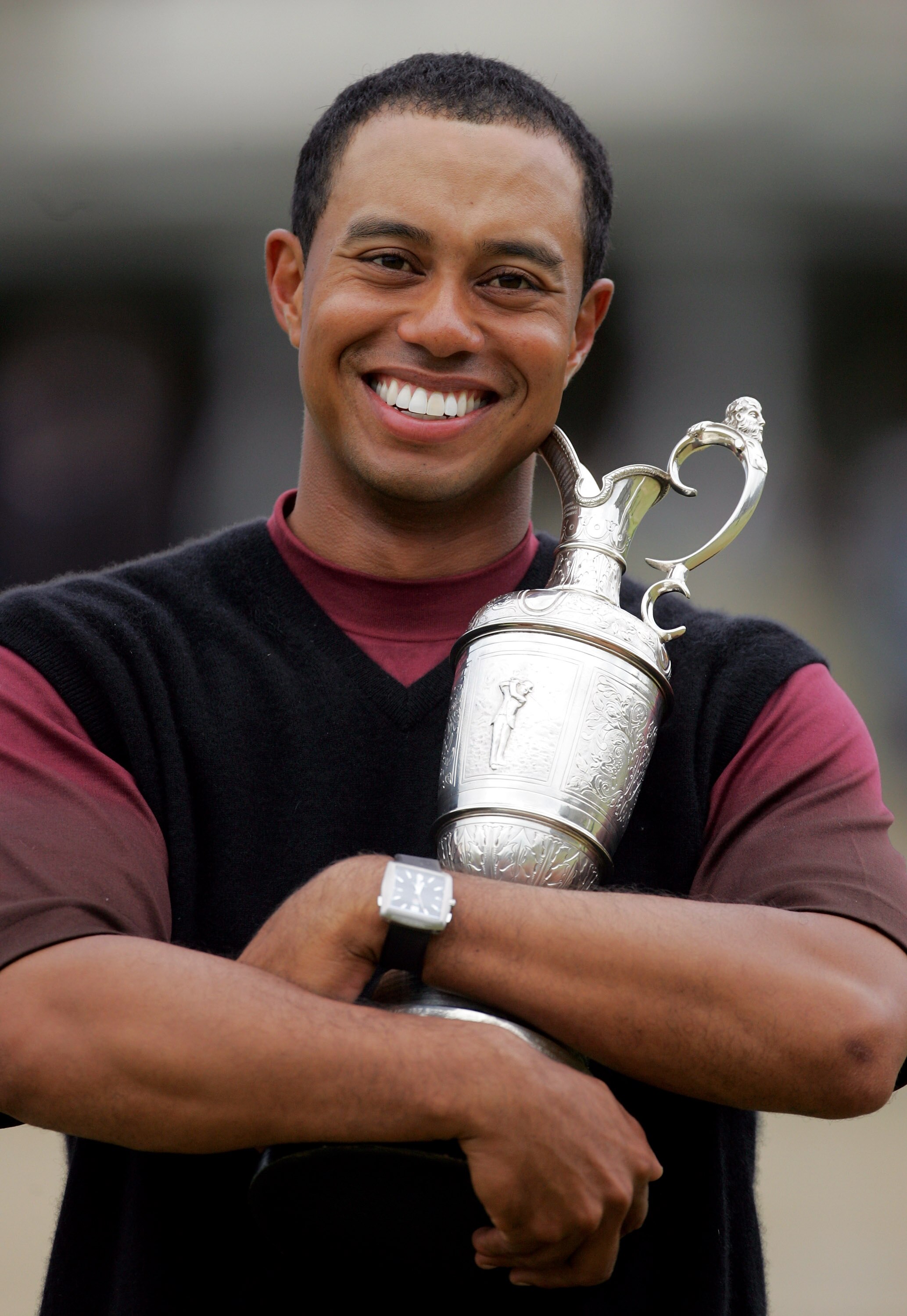 ST. ANDREWS, UNITED KINGDOM - JULY 17:  Tiger Woods of the USA hugs the Claret Jug after securing a five shot victory at the 134th Open Championship at Old Course, St Andrews Golf Links, July 17, 2005 in St Andrews, Scotland.  (Photo by Jamie Squire/Getty