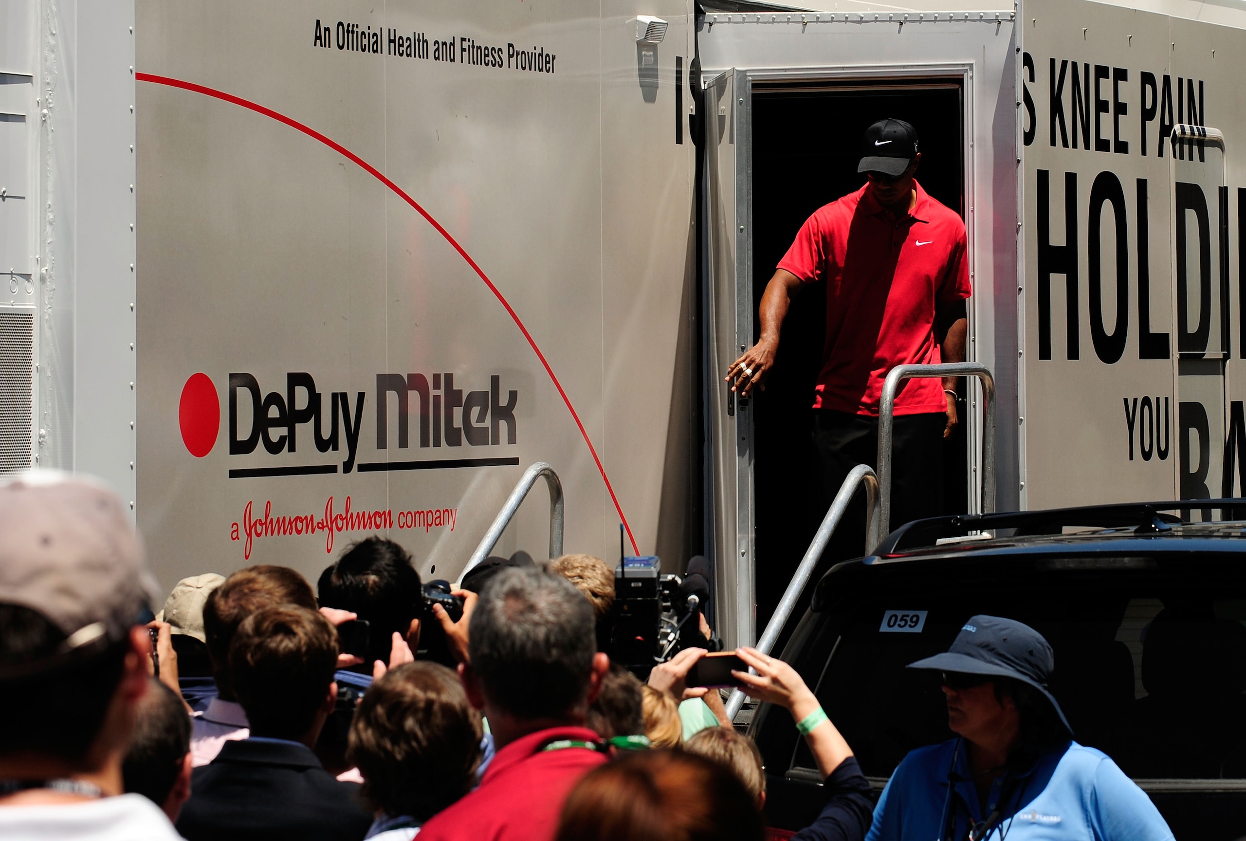 PONTE VEDRA BEACH, FL - MAY 09:  Tiger Woods walks out of the player fitness truck after withdrawing from the tournament on the seventh hole with a neck injury during the final round of THE PLAYERS Championship held at THE PLAYERS Stadium course at TPC Sa