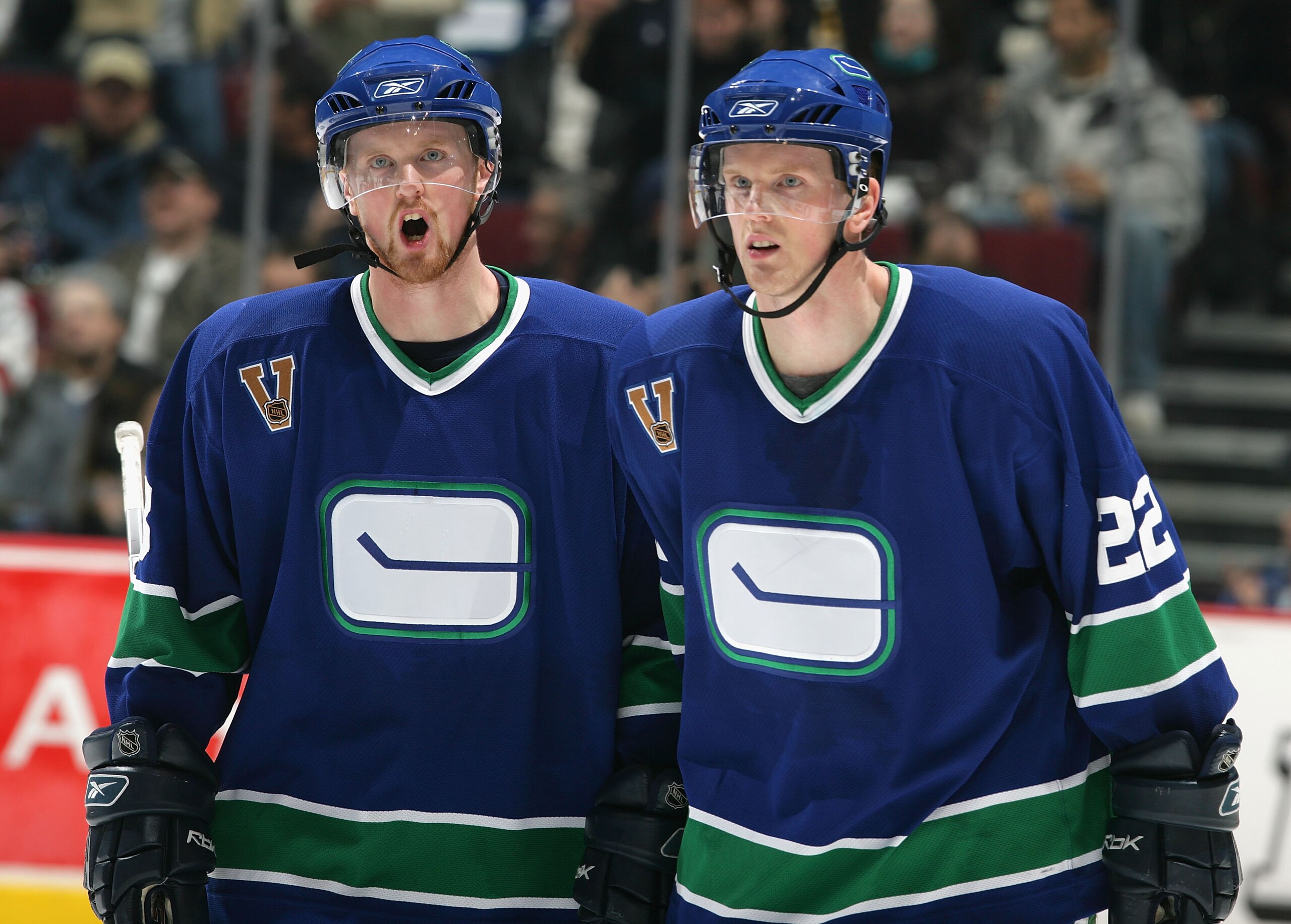 VANCOUVER - DECEMBER 4:  Twin brothers Henrik Sedin #33 and Daniel Sedin #22 of the Vancouver Canucks in action agaisnt the Boston Bruins during the NHL game at General Motors Place on December 4, 2005 in Vancouver, Canada. The Canucks defeated the Bruins