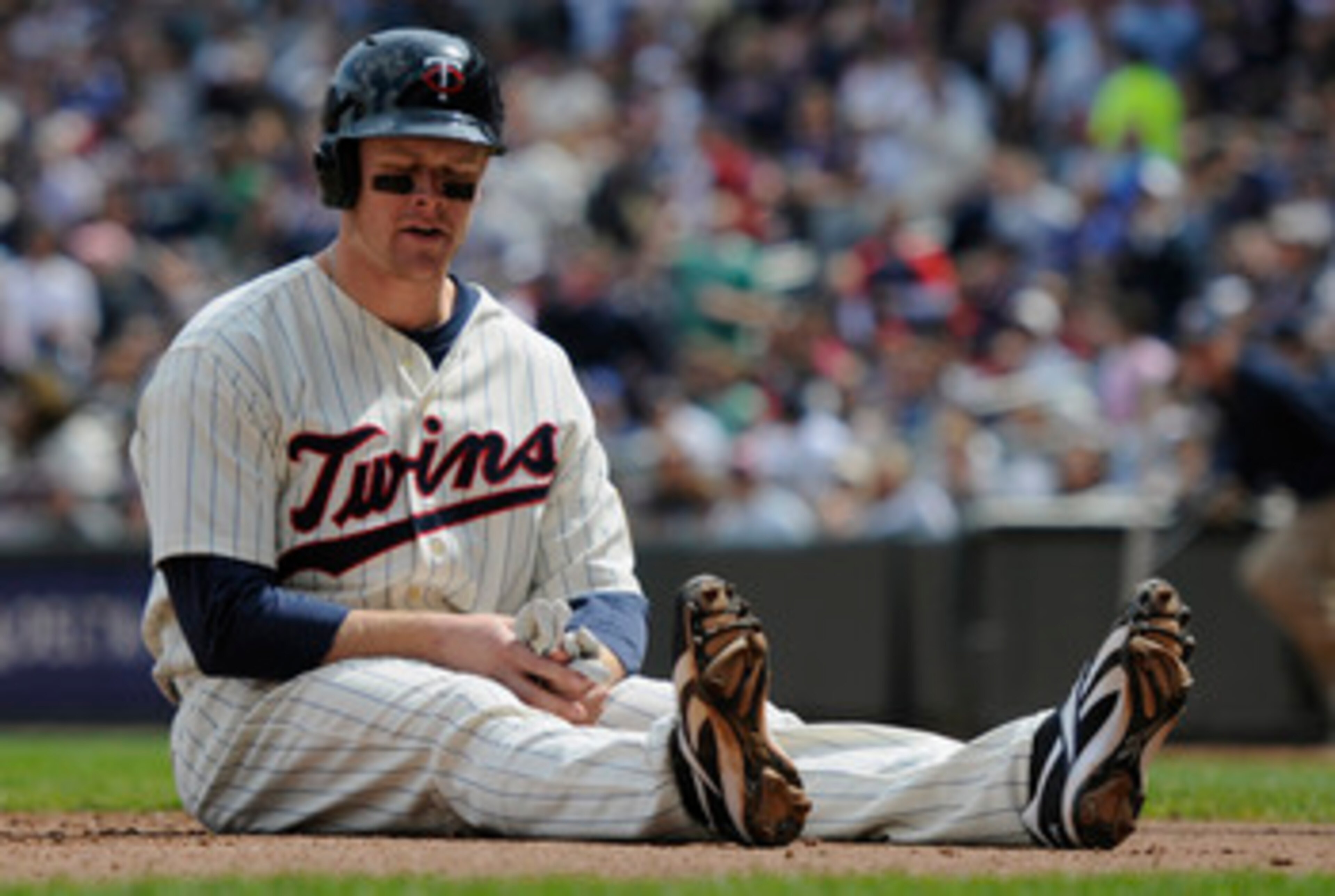 MINNEAPOLIS, MN - APRIL 24: Justin Morneau #33 of the Minnesota Twins reacts after being tagged out at home plate for the final out of the third inning against the Cleveland Indians during their game on April 24, 2011 at Target Field in Minneapolis, Minne