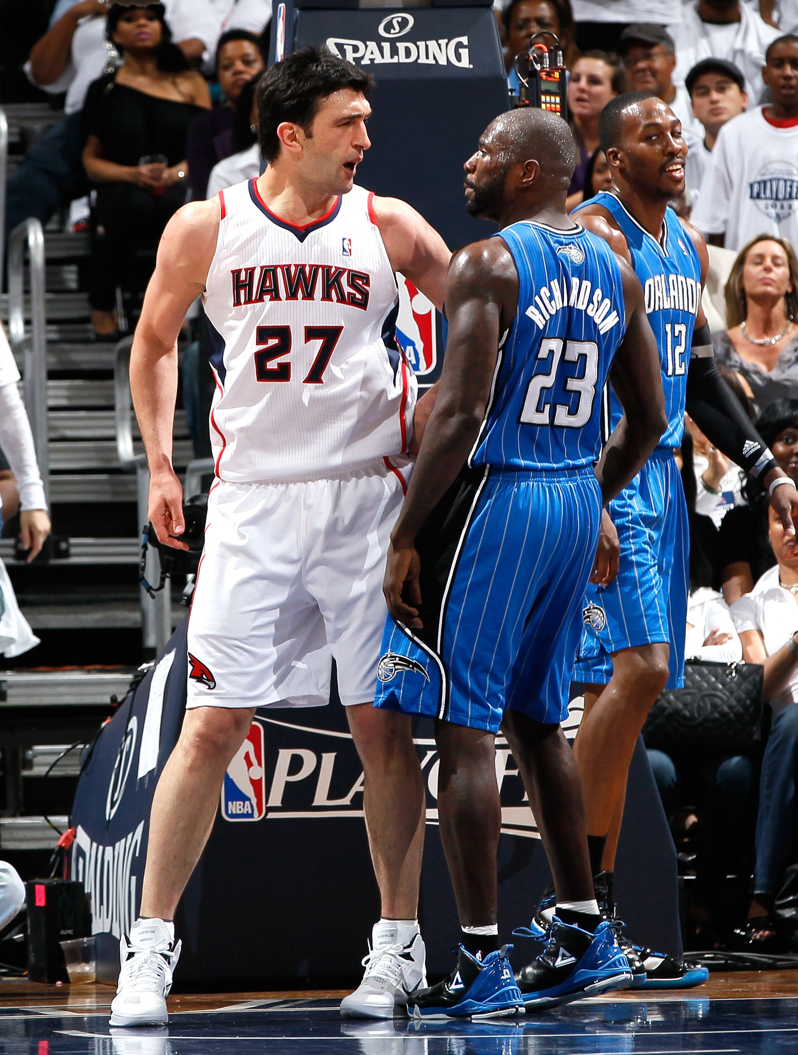 ATLANTA, GA - APRIL 22:  Zaza Pachulia #27 of the Atlanta Hawks and Jason Richardson #23 of the Orlando Magic exchange words after a foul by Pachulia against Dwight Howard #12 during Game Three of the Eastern Conference Quarterfinals in the 2011 NBA Playo