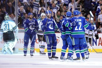 VANCOUVER, CANADA - MAY 18:  Daniel Sedin #22 of the Vancouver Canucks celebrates his first period goal against goaltender Antti Niemi #31 of San Jose Sharks with teammates in Game Two of the Western Conference Finals during the 2011 Stanley Cup Playoffs 