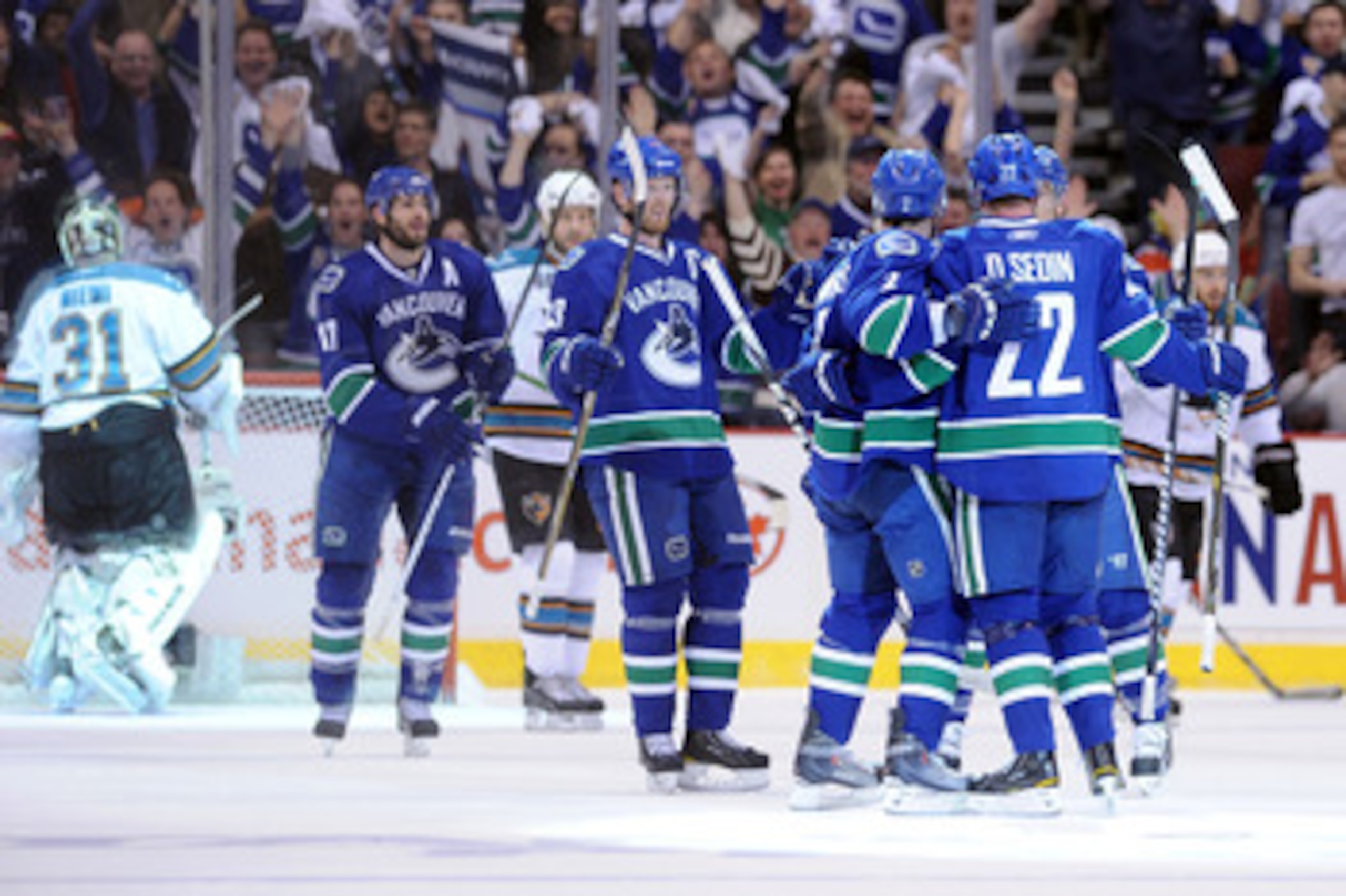 VANCOUVER, CANADA - MAY 18: Daniel Sedin #22 of the Vancouver Canucks celebrates his first period goal against goaltender Antti Niemi #31 of San Jose Sharks with teammates in Game Two of the Western Conference Finals during the 2011 Stanley Cup Playoffs VANCOUVER, CANADA - MAY 18: Daniel Sedin #22 of the Vancouver Canucks celebrates his first period goal against goaltender Antti Niemi #31 of San Jose Sharks with teammates in Game Two of the Western Conference Finals during the 2011 Stanley Cup Playoffs