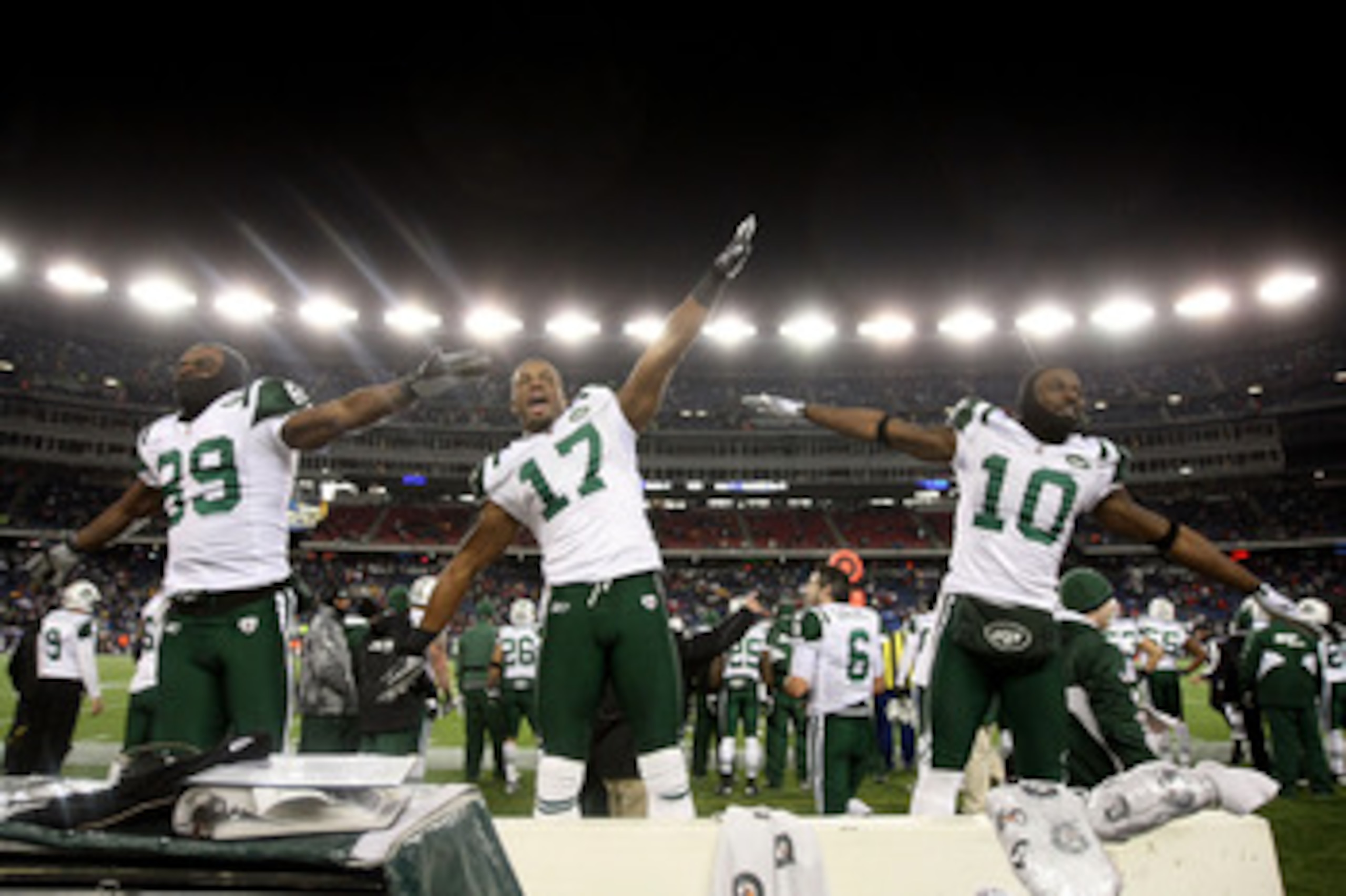 FOXBORO, MA - JANUARY 16:  Jerricho Cotchery #89, Braylon Edwards #17 and Santonio Holmes #10 of the New York Jets celebrate their 28 to 21 victory over the New England Patriots during their 2011 AFC divisional playoff game at Gillette Stadium on January 