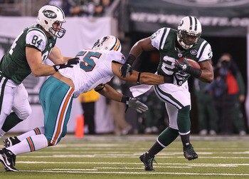 EAST RUTHERFORD, NJ - DECEMBER 12: Shonn Greene #23 of the New York Jets rushes against the Miami Dolphins at New Meadowlands Stadium on December 12, 2010 in East Rutherford, New Jersey.  (Photo by Nick Laham/Getty Images)