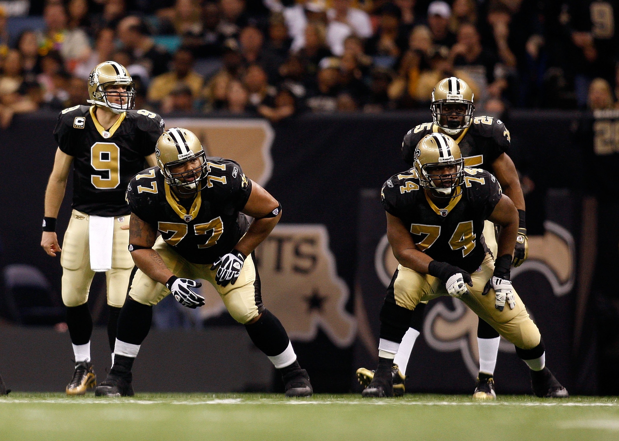 NEW ORLEANS - JANUARY 16: (L-R) Offensive lineman Carl Nicks #77 and Jermon Bushrod #74 of the New Orleans Saints get set to pass protect as Drew Brees #9 and Reggie Bush #25 await the snap against the Arizona Cardinals during the NFC Divisional Playoff NEW ORLEANS - JANUARY 16: (L-R) Offensive lineman Carl Nicks #77 and Jermon Bushrod #74 of the New Orleans Saints get set to pass protect as Drew Brees #9 and Reggie Bush #25 await the snap against the Arizona Cardinals during the NFC Divisional Playoff