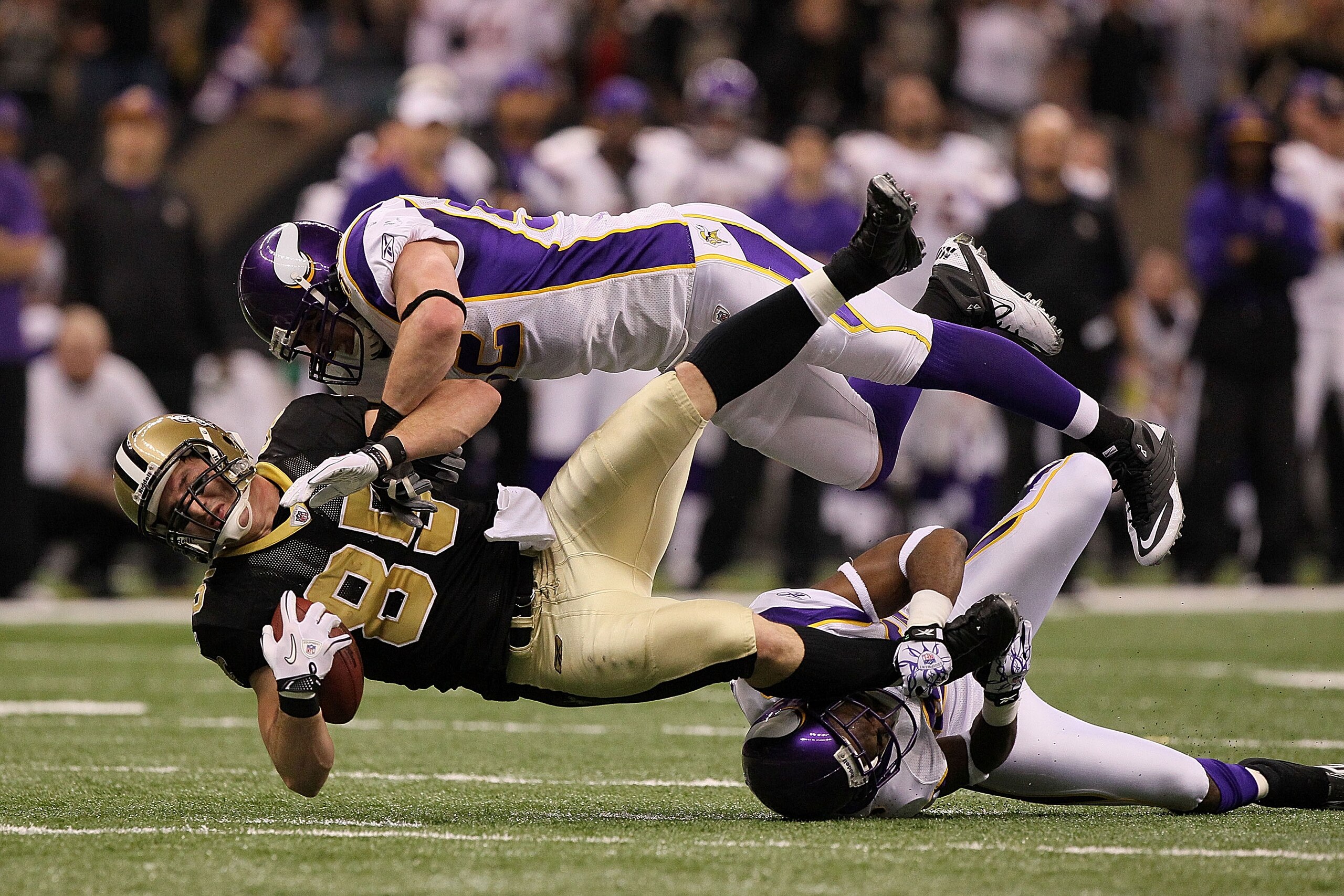 NEW ORLEANS - JANUARY 24:  Jeremy Shockey #88 of the New Orleans Saints gets tackled by Chad Greenway #52 and Antoine Winfield #26 of the Minnesota Vikings after catching a pass for a first down during the NFC Championship Game at the Louisana Superdome o