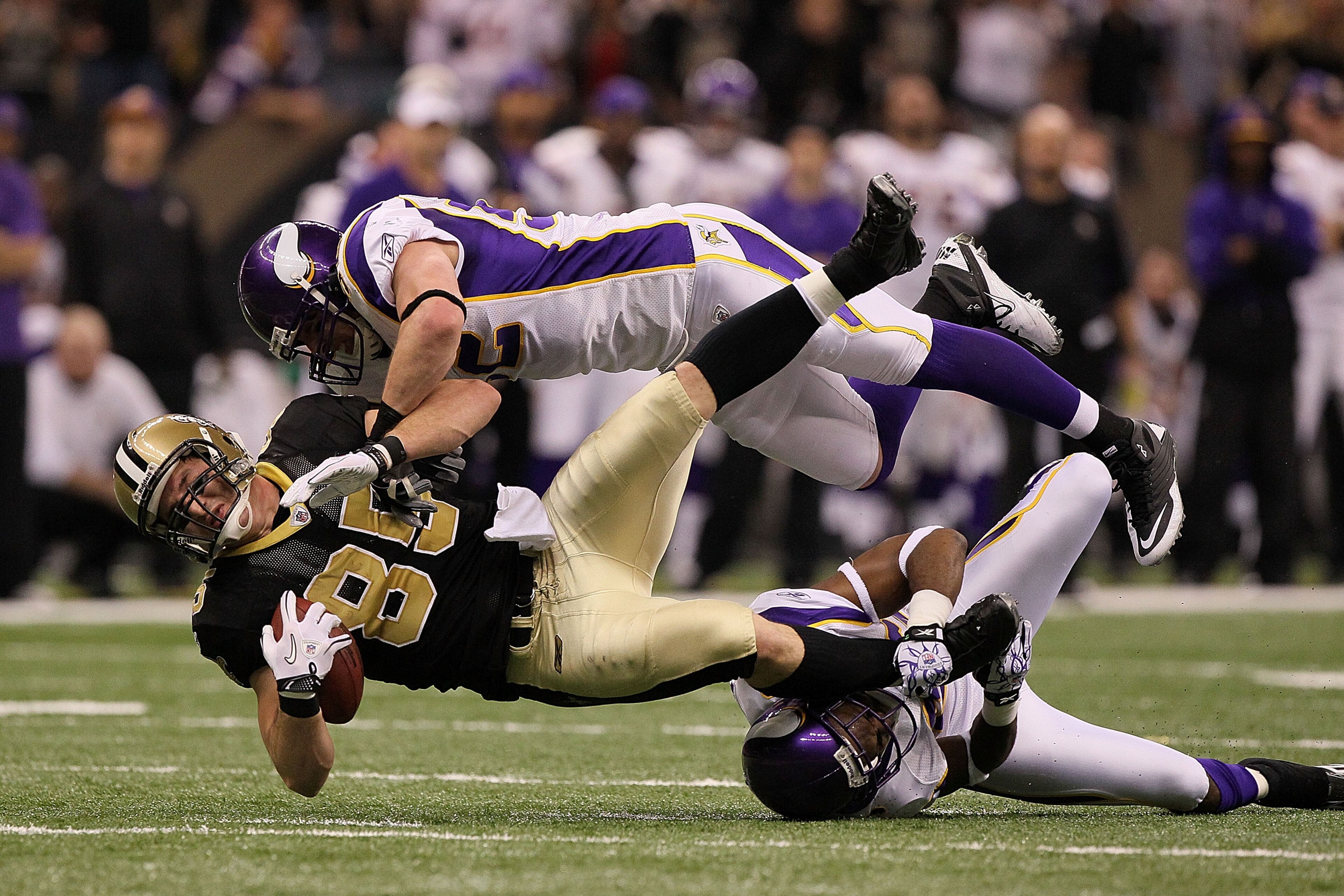 NEW ORLEANS - JANUARY 24: Jeremy Shockey #88 of the New Orleans Saints gets tackled by Chad Greenway #52 and Antoine Winfield #26 of the Minnesota Vikings after catching a pass for a first down during the NFC Championship Game at the Louisana Superdome o NEW ORLEANS - JANUARY 24: Jeremy Shockey #88 of the New Orleans Saints gets tackled by Chad Greenway #52 and Antoine Winfield #26 of the Minnesota Vikings after catching a pass for a first down during the NFC Championship Game at the Louisana Superdome o