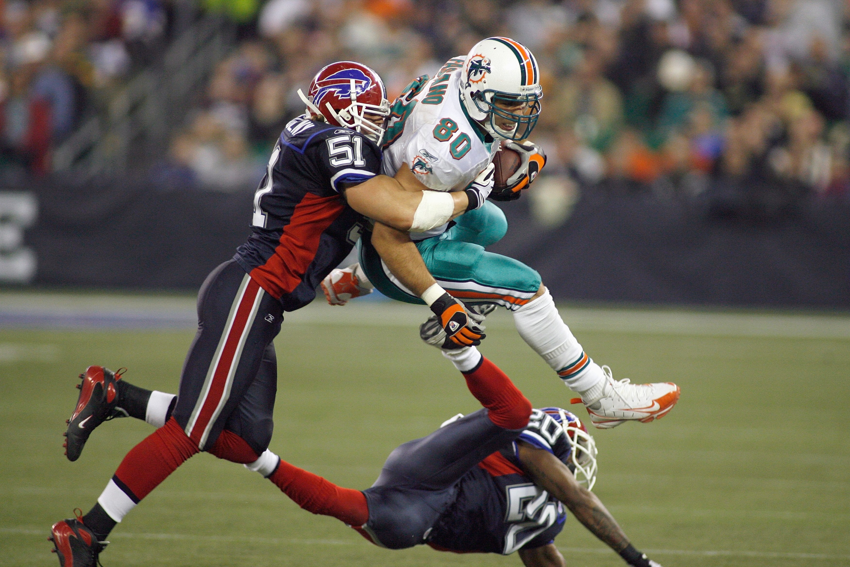 TORONTO, ON - DECEMBER 07: Anthony Fasano #80 of the Miami Dolphins is stopped by Paul Posluzny #51 of the Buffalo Bills on December 7, 2008 at Rogers Centre in Toronto, Ontario, Canada. The Dolphins won 16-3. (Photo by Rick Stewart/Getty Images)