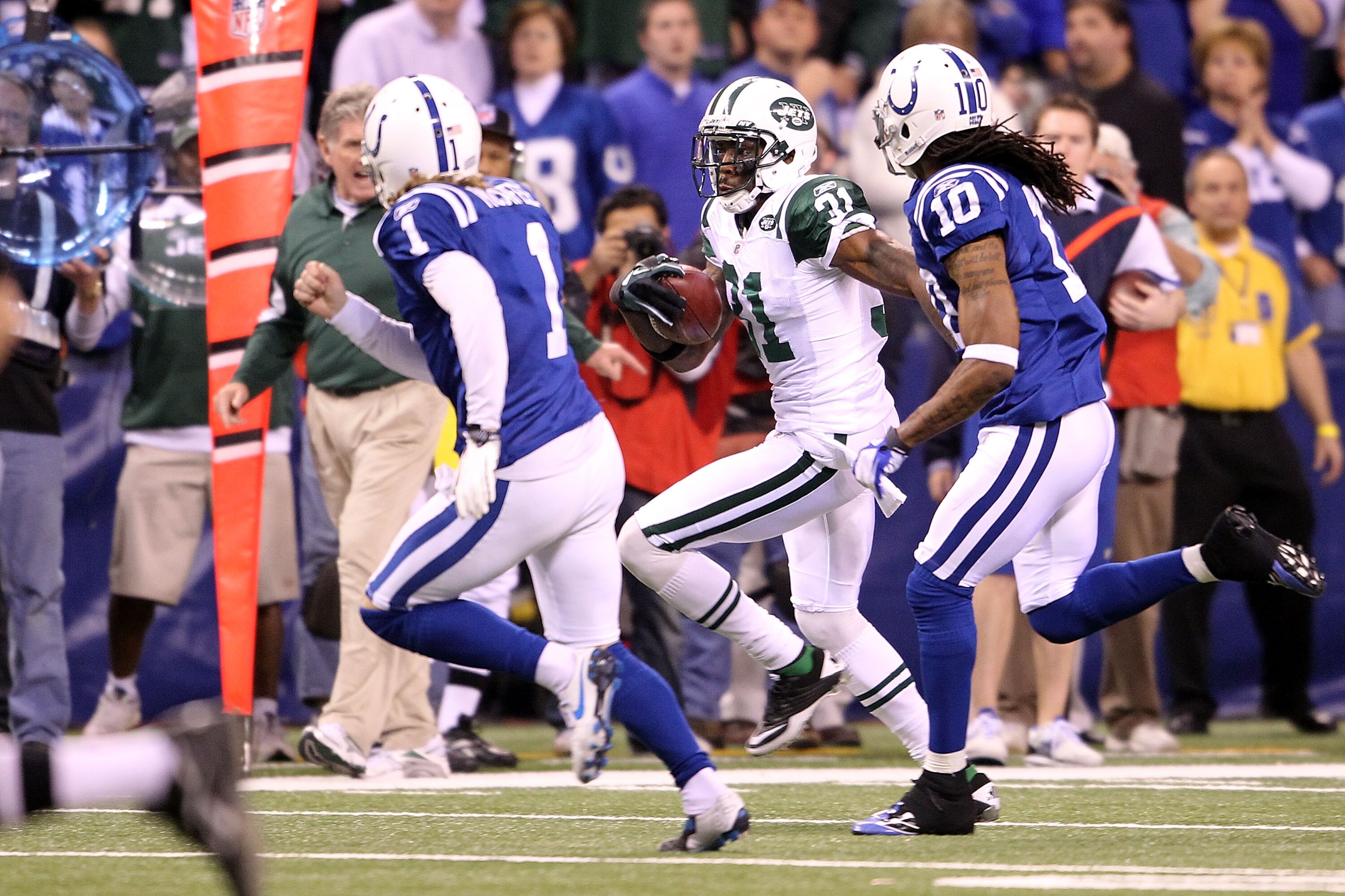INDIANAPOLIS, IN - JANUARY 08:  Antonio Cromartie #31 of the New York Jets returns a kickoff 47-yards in the final minute of the fourth quarter against kicker Pat McAfee #1 of the Indianapolis Colts during their 2011 AFC wild card playoff game at Lucas Oi