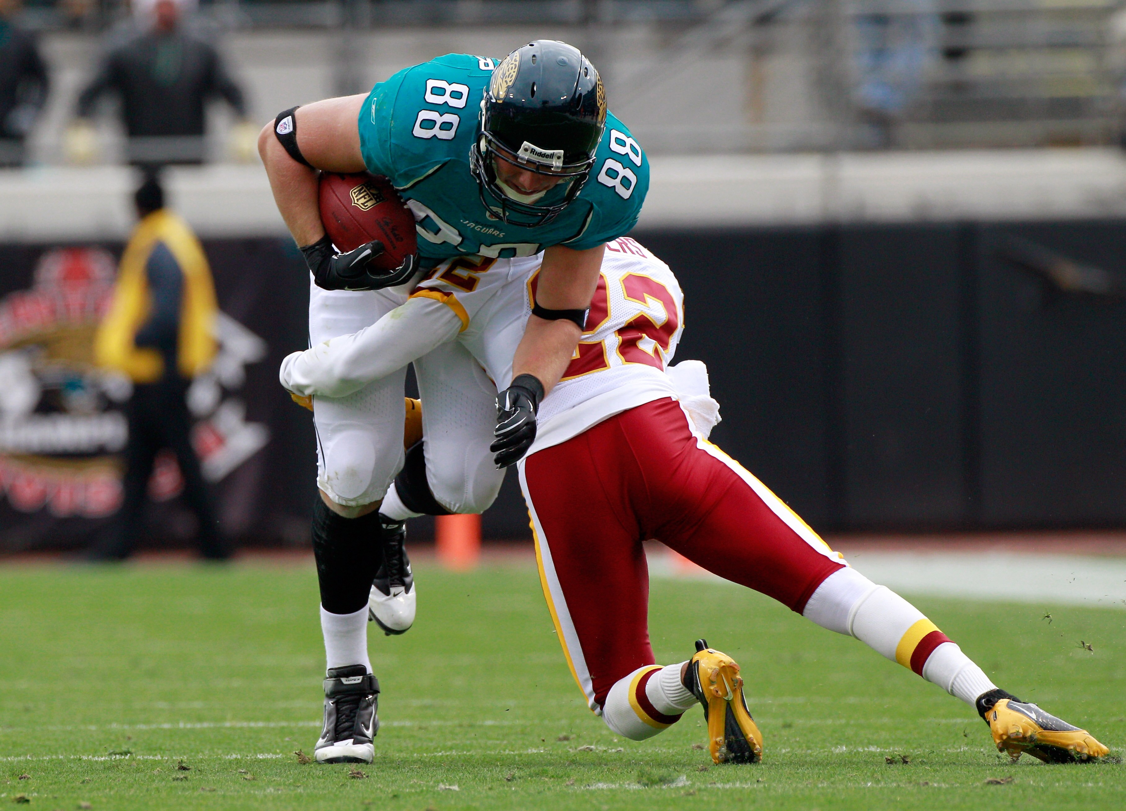 JACKSONVILLE, FL - DECEMBER 26:  Zach Potter #88 of the Jacksonville Jaguars is tackled by Carlos Rogers #22 of the Washington Redskins during the game at EverBank Field on December 26, 2010 in Jacksonville, Florida.  (Photo by Sam Greenwood/Getty Images)