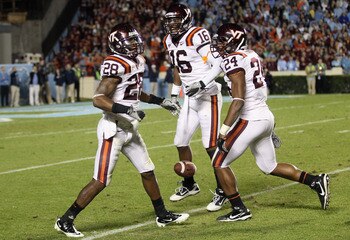 CHAPEL HILL, NC - NOVEMBER 13:  Alonzo Tweedy #28 of the Virginia Tech Hokies celebrates with teammates Zach Luckett #16 and Tariq Edwards #24 after recovering a fumble against the North Carolina Tar Heels during their game at Kenan Stadium on November 13
