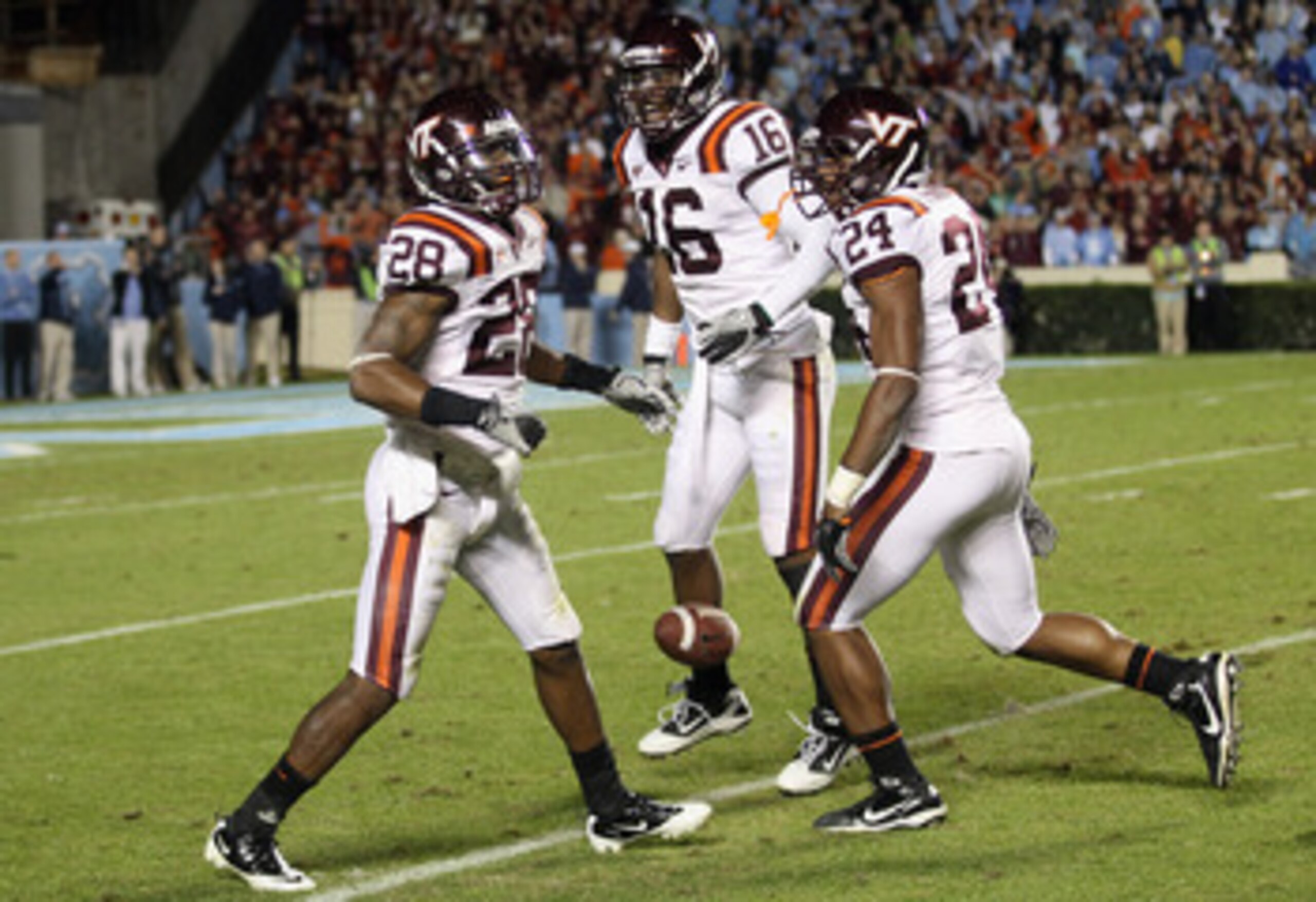 CHAPEL HILL, NC - NOVEMBER 13:  Alonzo Tweedy #28 of the Virginia Tech Hokies celebrates with teammates Zach Luckett #16 and Tariq Edwards #24 after recovering a fumble against the North Carolina Tar Heels during their game at Kenan Stadium on November 13